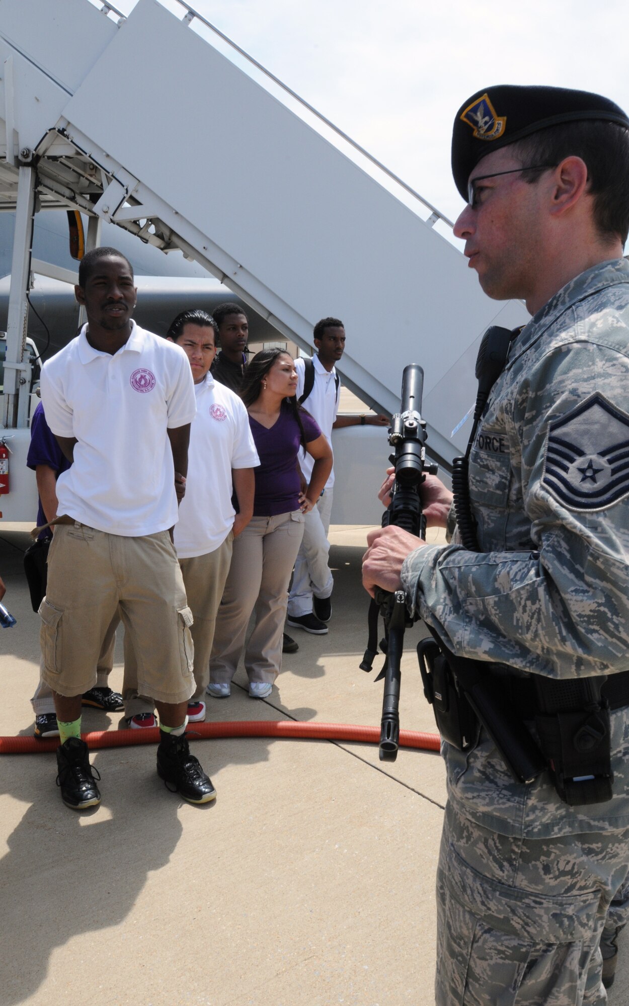 Master Sgt. Eric Marsh, 316th Security Forces Squadron, speaks with students from Cardozo Senior High School, Washington, DC, about his duties protecting the flightline, here May 26. 20 students from the high school toured Joint Base Andrews, Md., and also spoke with Airmen from the 459th Air Refueling Wing and the 316th Wing about career opportunities in both the Air Force Reserve and regular Air Force. (U.S. Air Force photo/Staff Sgt. Steve Lewis)
