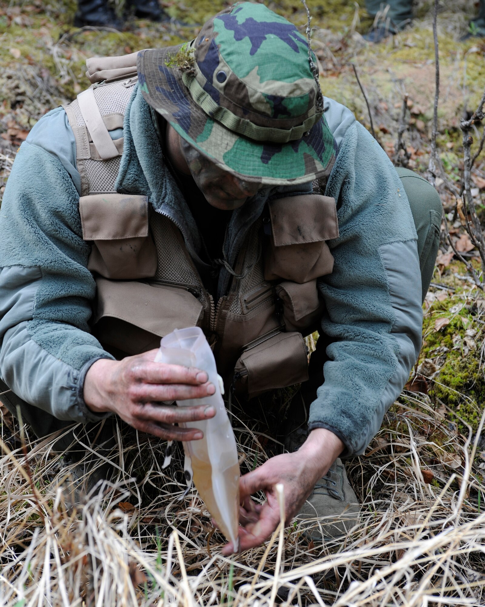 An Airman fills a bladder full of water May 20, 2010, Eielson Air Force Base, Alaska. The Airman was taking part in a combat survival and evasion scenario during the May operational readiness inspection. The Airmen is assigned to the 168th Air Refueling Wing. (U.S. Air Force photo/Willard E. Grande II)