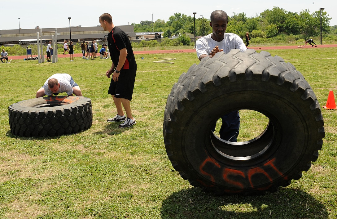 LANGLEY AIR FORCE BASE, Va. -- Senior Airman Ebo Yankson, 633d Force Support Squadron force management specialist, and Staff Sgt. Carl Jewell, 633d Force Support Squadron formal training noncommissioned officer in charge, participate in a prism sports obstacle course May 21.  Prism Sports is a high intensity workout designed to develop an athlete’s power, movement biomechanics, and strength while also reducing the likelihood of non-contact injury by teaching correct exercise technique, increasing lean body mass, gaining strength and flexibility, correcting postural deviations, and developing the body’s metabolic energy system.  (U.S. Air Force Photo/Staff Sgt. Christina M. Styer)