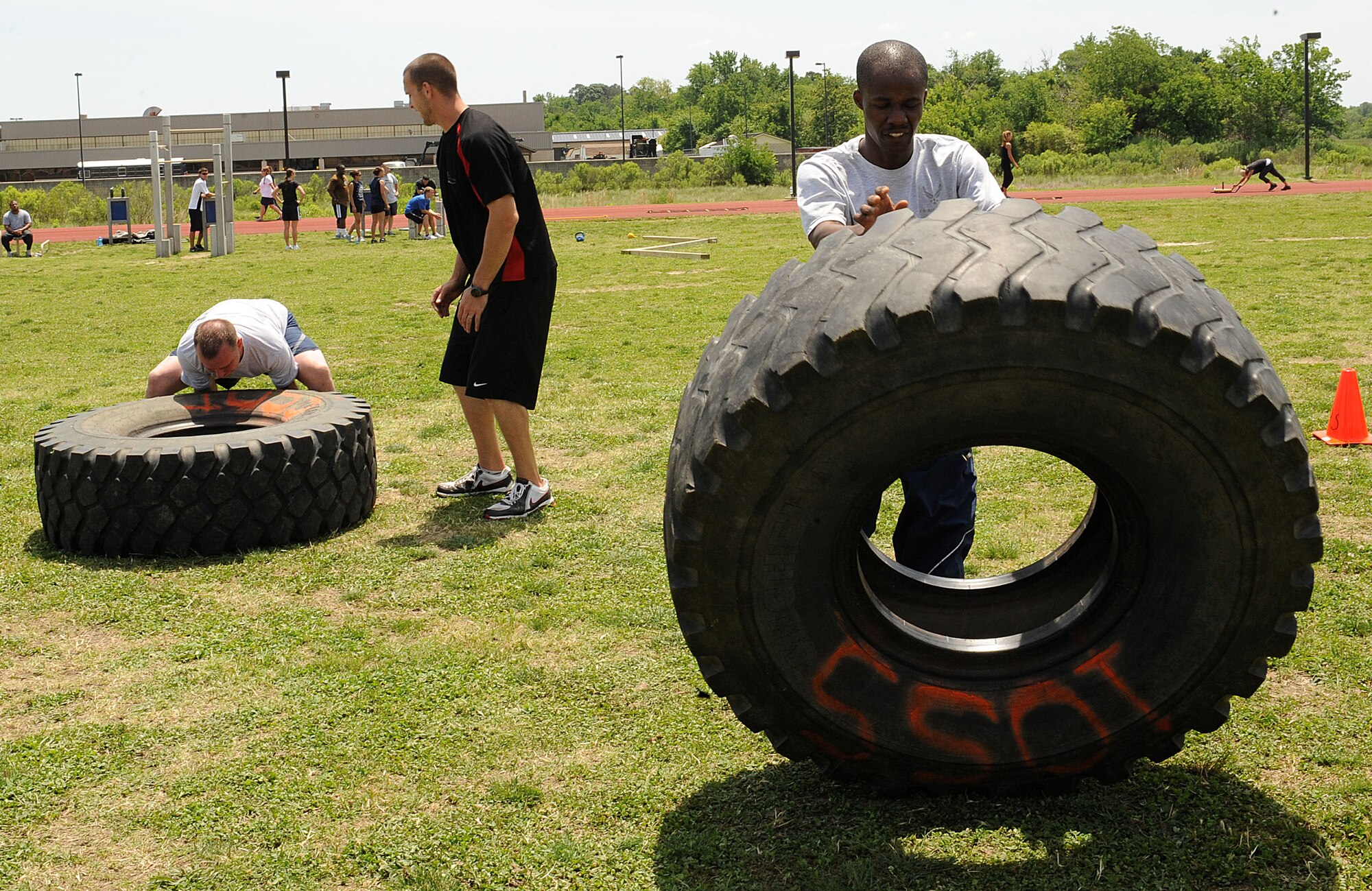 LANGLEY AIR FORCE BASE, Va. -- Senior Airman Ebo Yankson, 633d Force Support Squadron force management specialist, and Staff Sgt. Carl Jewell, 633d Force Support Squadron formal training noncommissioned officer in charge, participate in a prism sports obstacle course May 21.  Prism Sports is a high intensity workout designed to develop an athlete’s power, movement biomechanics, and strength while also reducing the likelihood of non-contact injury by teaching correct exercise technique, increasing lean body mass, gaining strength and flexibility, correcting postural deviations, and developing the body’s metabolic energy system.  (U.S. Air Force Photo/Staff Sgt. Christina M. Styer)