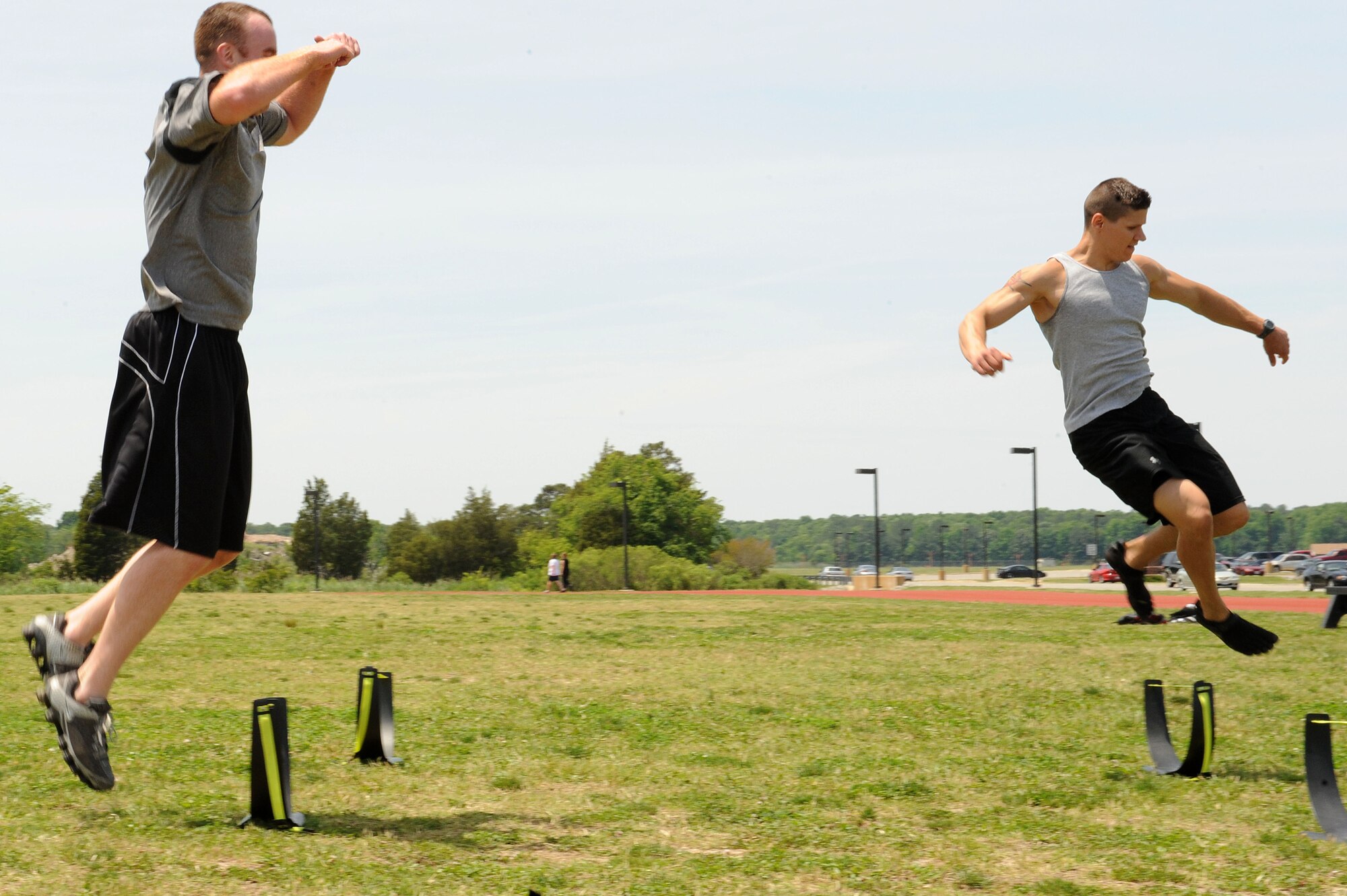 LANGLEY AIR FORCE BASE, Va. -- Senior Master Sgt. Bryan Shipman, 633d Force Support Squadron sports and fitness section chief, and 2nd Lt. David Earl, 633d Contracting Squadron contract specialist, participate in a prism sports obstacle course May 21.  Prism Sports is a high intensity workout designed to develop an athlete’s power, movement biomechanics, and strength while also reducing the likelihood of non-contact injury by teaching correct exercise technique, increasing lean body mass, gaining strength and flexibility, correcting postural deviations, and developing the body’s metabolic energy system.  (U.S. Air Force Photo/Staff Sgt. Christina M. Styer)