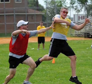 LANGLEY AIR FORCE BASE, Va. -- Airman 1st Class Joshua Marrs, 30th Intelligence Squadron intelligence analyst, scores after catching the Frisbee while Senior Master Sgt. Robert Farthing, 10th Intelligence Squadron operations flight superintendent  plays defense May 26.  Ultimate Frisbee, along with other events were held as part of the 480th Intelligence, Surveillance, and Reconnaissance Wing Warrior Games.  (U.S. Air Force photo/Senior Airman Zachary Wolf)   

