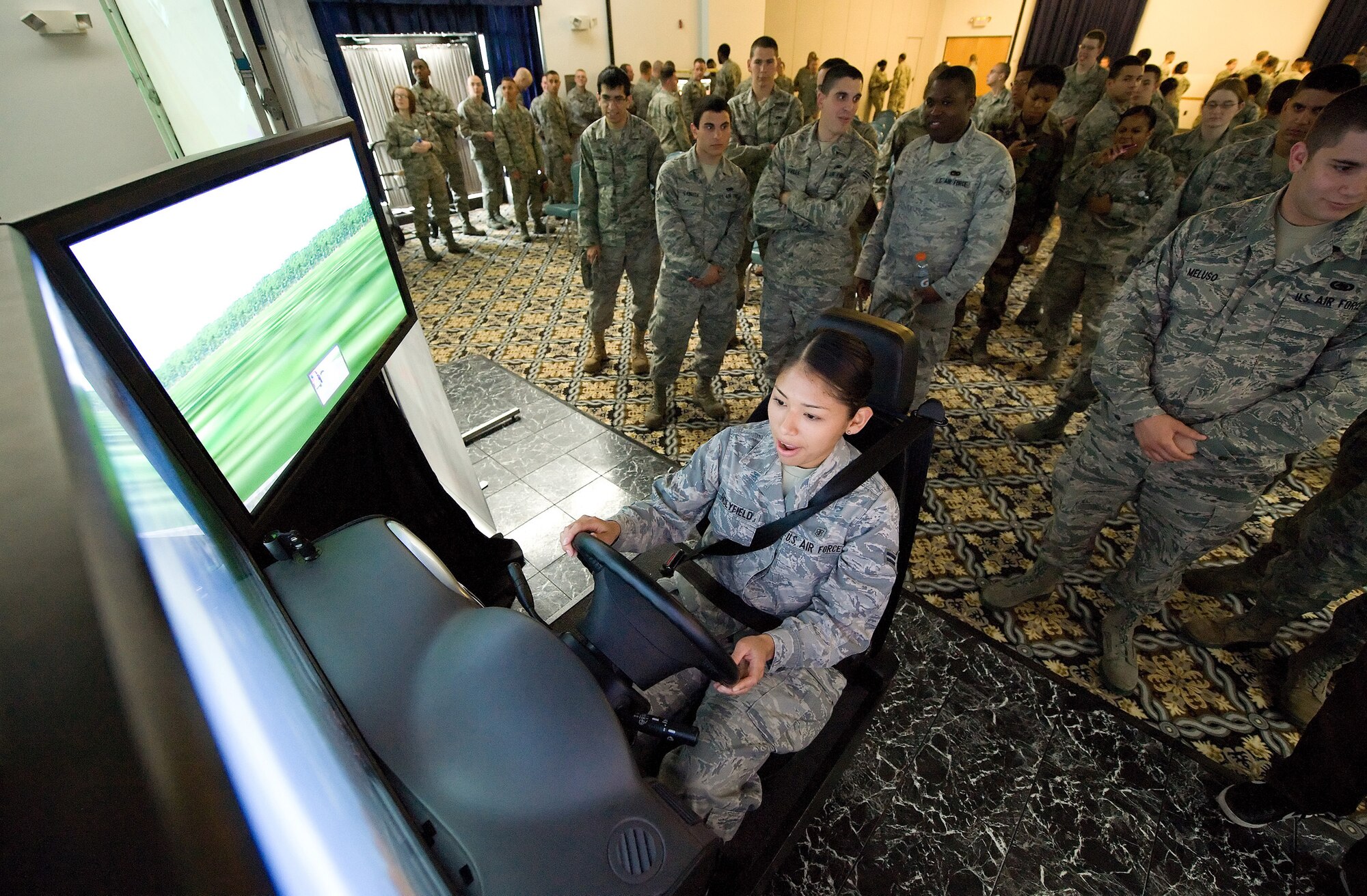 Airman 1st Class Rossmery HolyField, 436th Medical Operations Squadron, uses a 2.5 million-dollar simulator during the Save a Life Tour, a National High Impact Alcohol Awareness Program at The Landings Club May 25. The 180-degree field of view, on multi-screens, helps to simulate a realistic driving experience. (U.S. Air Force photo/Jason Minto)