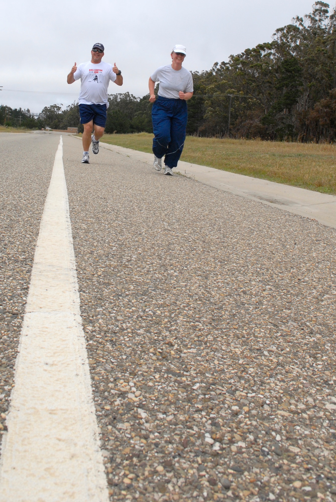 VANDENBERG AIR FORCE BASE, Calif. -- Charging full steam ahead, Jeff Claxton, of the 30th Space Wing safety office, and Capt. Susan Bersuch, of the 30th Operations Support Squadron,  run a 5K during the May Fitness Expo here Tuesday, May 25, 2010.  During the expo, fitness events were held to encourage personnel on base to create healthy standards of fitness and educate them on different ways to exercise.  (U.S. Air Force photo/Senior Airman Andrew Satran)