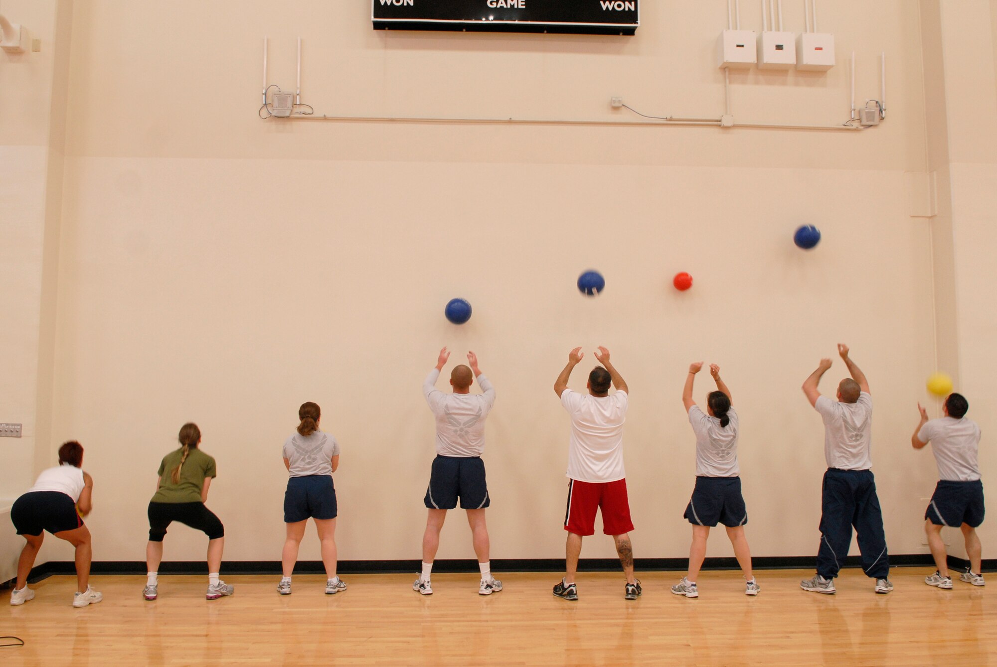 VANDENBERG AIR FORCE BASE, Calif. -- Tossing weighted medicine balls, Team V members train during a Hardcore Class at the base fitness center here Tuesday, May 25, 2010.  The training focused on weight training, cardio and using specific muscle groups.  (U.S. Air Force photo/Senior Airman Andrew Satran)