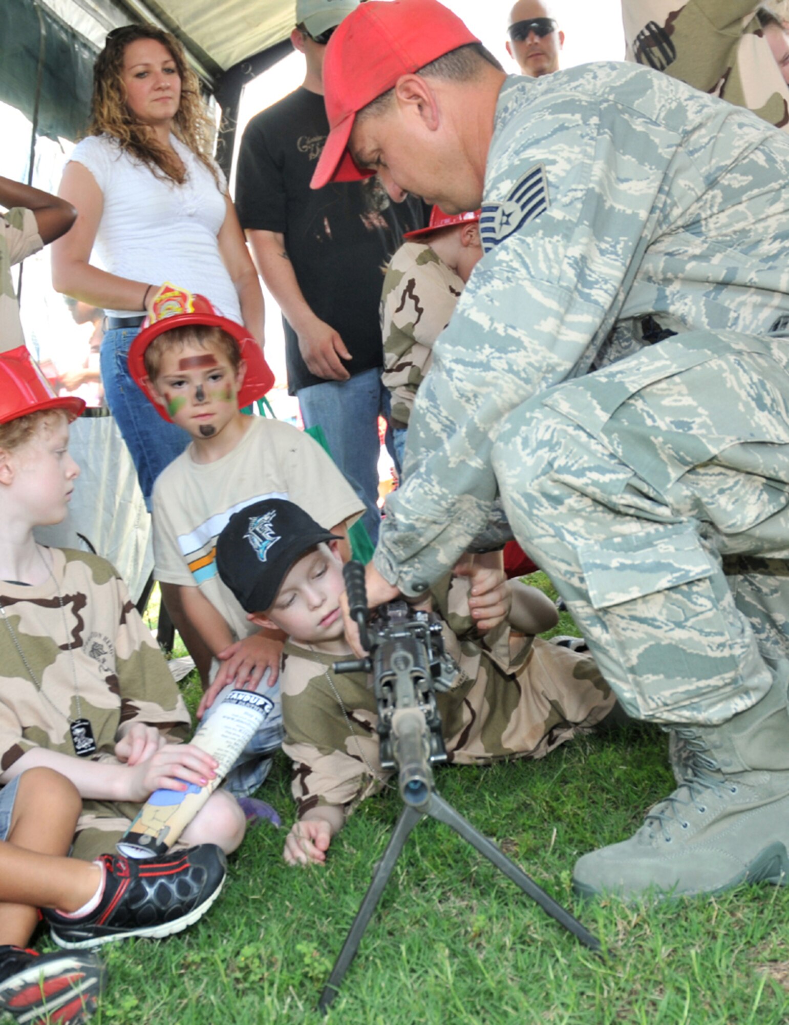 Montgomery Wilson, 8,  son of Tech. Sgt. Greg and Rebecca Wilson, 85th Engineering Installation Squadron, receives instruction on the M-249 from Tech. Sgt. Barry Hardy, 81st Security Forces Squadron.  Sergeant Wilson is currently deployed.  (U.S. Air Force photo by Adam Bond)