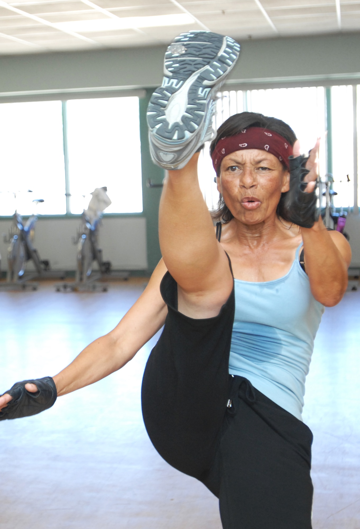 VANDENBERG AIR FORCE BASE, Calif. –Leading the cardio kickboxing class, Anita Tubbs, performs various moves at the Airman and Family Readiness Center here Tuesday, May 25, 2010. Ms. Tubbs is the primary trainer at the age of 57. (U.S. Air Force photo/Senior Airman Christopher Hubenthal)
