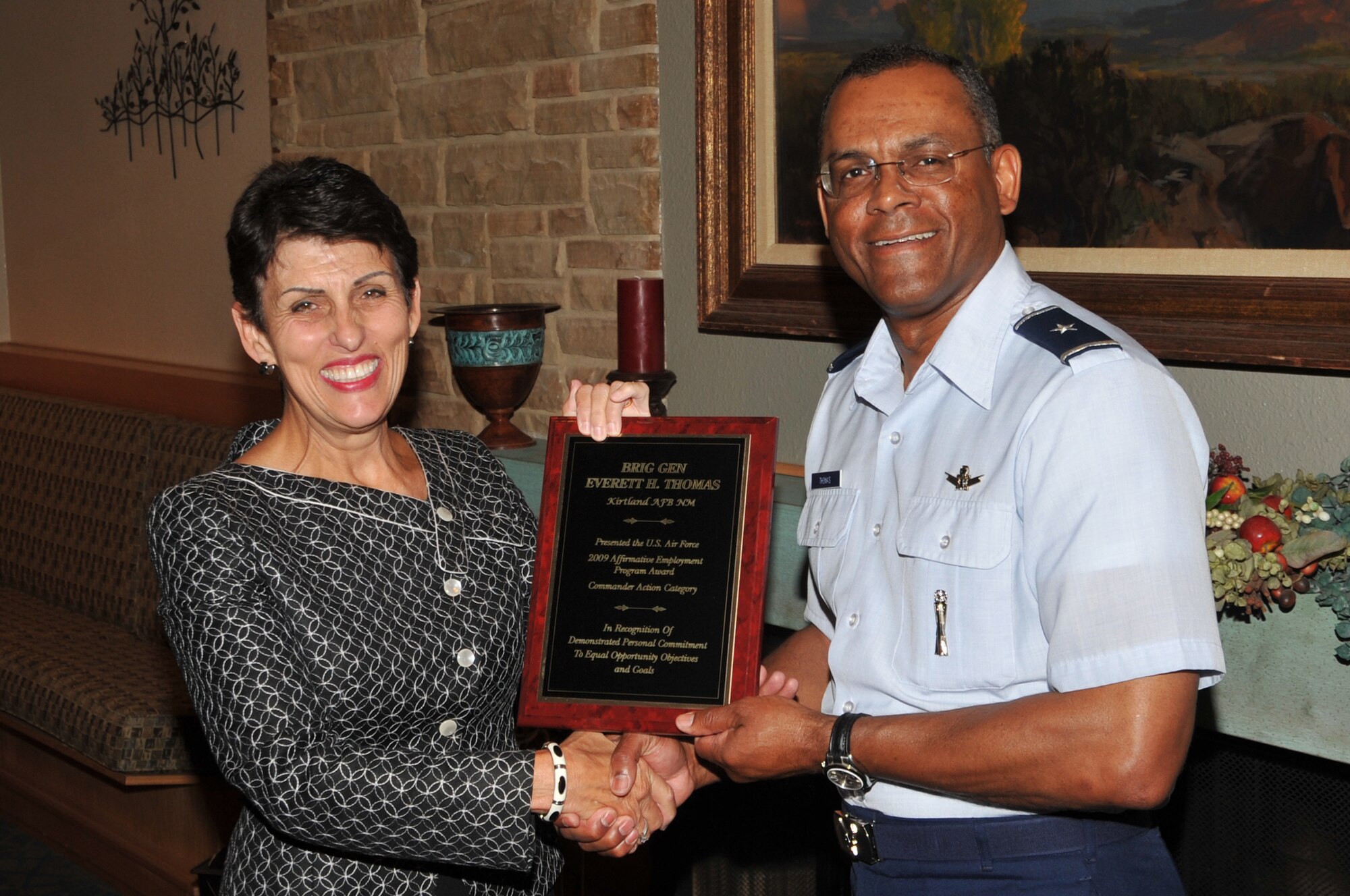Diana Filliman, Air Force Nuclear Weapons Center Executive Director, congratulates Brig. Gen. Everett Thomas, AFNWC commander, on receiving the Air Force 2009 Affirmative Employment Program Award at the May 6 Affirmative Employment Community Outreach Breakfast. Photo by Marie Vanover