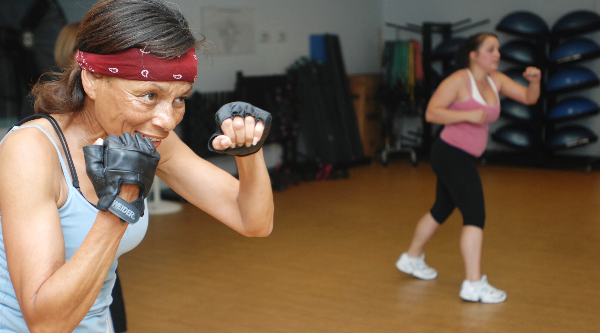 VANDENBERG AIR FORCE BASE, Calif. – Anita Tubbs, the class instructor, demonstrates a move during a cardio kickboxing class at the Airman and Family Readiness Center here Tuesday, May 25, 2010. Ms. Tubbs is the primary instructor for cardio kickboxing, total body conditioning, salsa sizzle and the cycling class. (U.S. Air Force photo/Senior Airman Christopher Hubenthal))