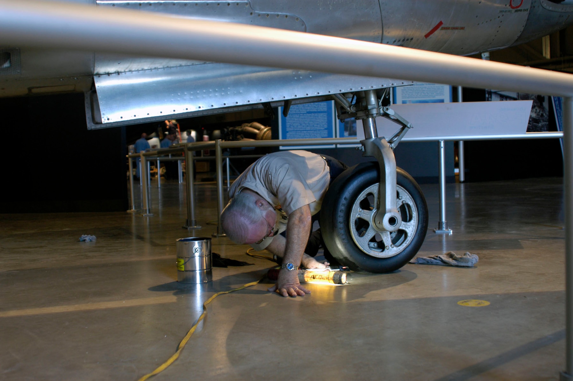 DAYTON, Ohio (05/2010) -- In preparation for the 60th anniversary of the Korean War, the National Museum of the U.S. Air Force is renovating its Korean War exhibit. Here, a restoration volunteer puts finishing touches on the F-84. (U.S. Air Force photo)