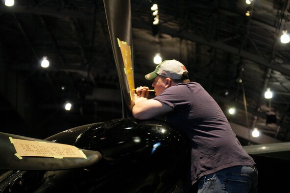 DAYTON, Ohio (05/2010) -- In preparation for the 60th anniversary of the Korean War, the National Museum of the U.S. Air Force is renovating its Korean War exhibit. Here, a restoration specialist paints stenciling on the F-82. (U.S. Air Force photo)