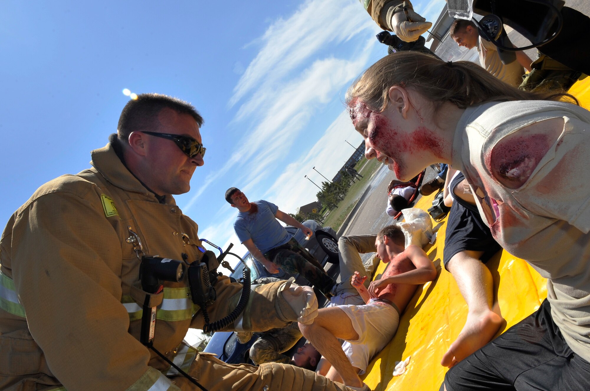 BUCKLEY AIR FORCE BASE, Colo. -- Airman 1st Class Brittany Carlisle, 460th Comptroller Squadron, receives treatment from an emergency responder. Emergency response teams reacted to multiple casualty simulations across the base May 21. (U.S. Air Force photo by Airman 1st Class Paul Labbe)