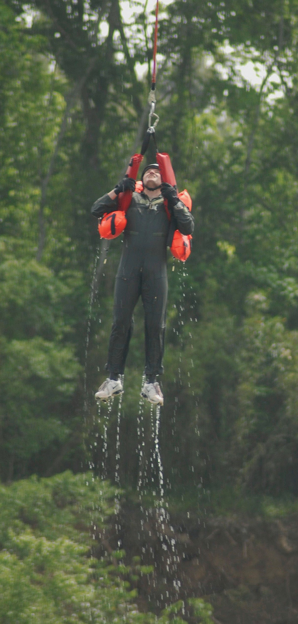 Lt. Col. Geoffrey Gibbs of Air University at Maxwell Air Force Base gets hoisted from the Alabama River during water-survival training.  (Air Force photo by Gene H. Hughes)
