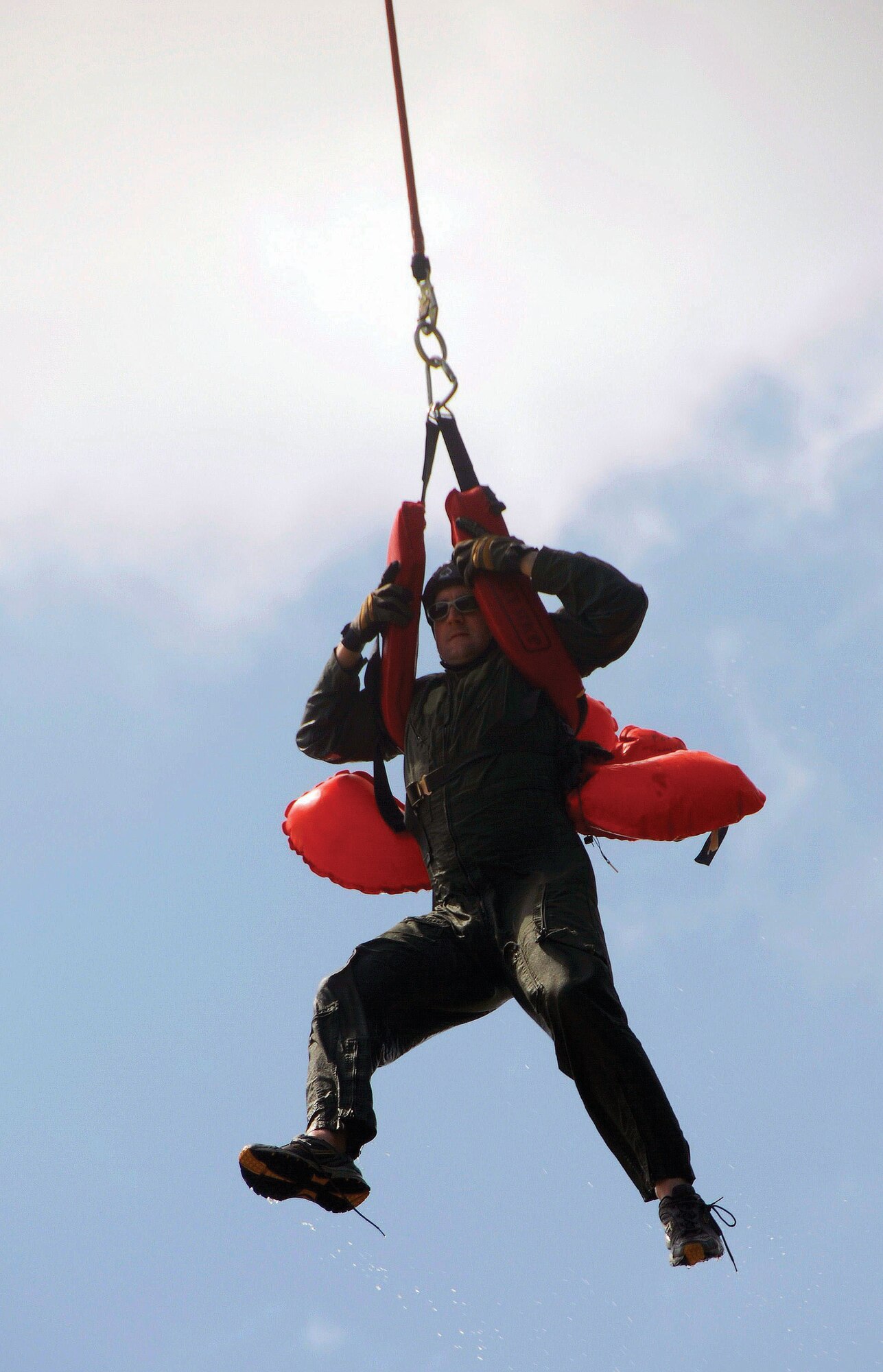 Capt. Samuel Manno gets hoisted by a helicopter during recent water-survival training conducted by the 908th Airift Wing in conjunction with the Alabama Department of Public Safety.  (Air Force photo by Gene H. Hughes)