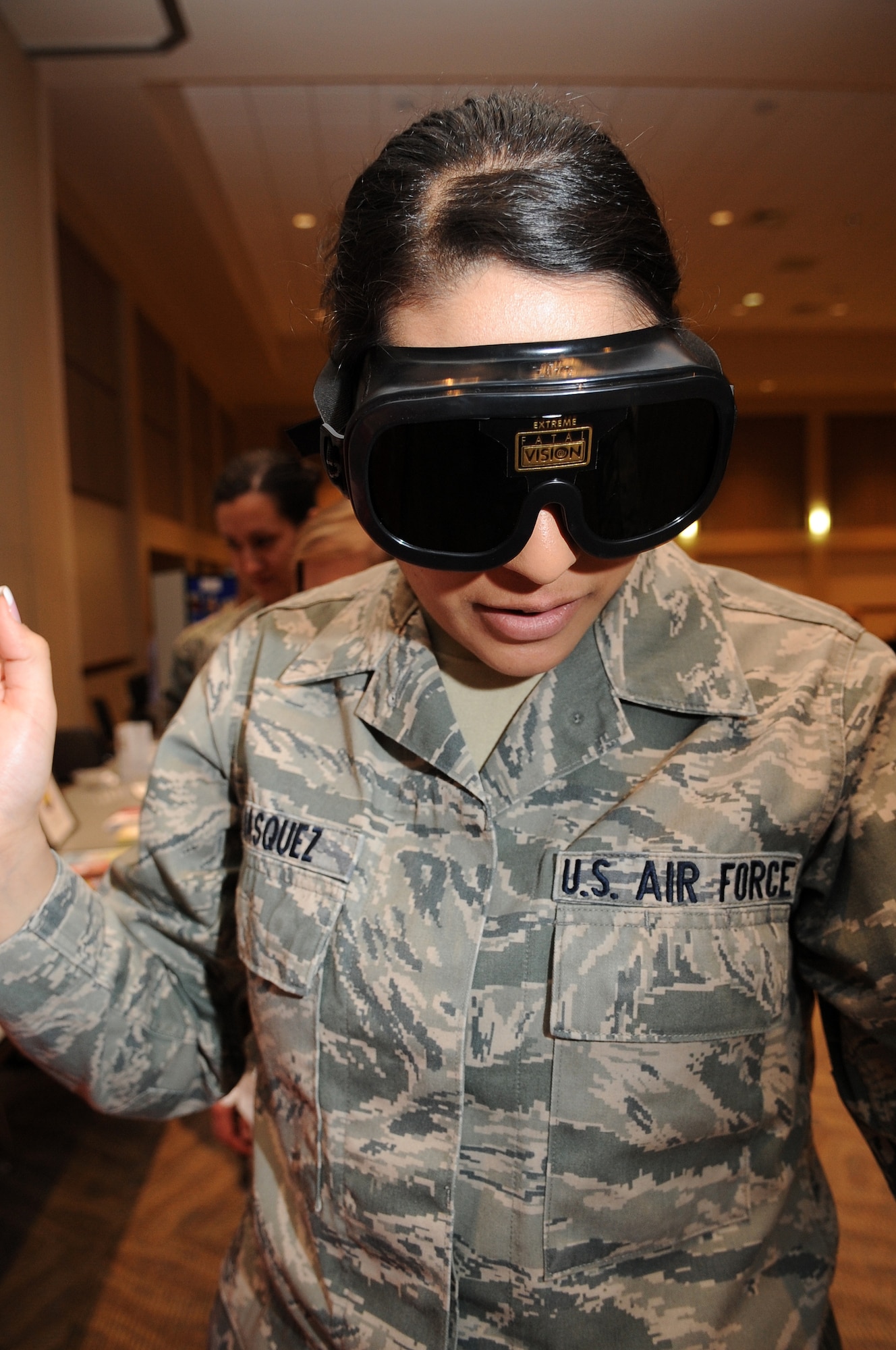 BUCKLEY AIR FORCE BASE, Colo.-- Airman 1st Class Manisha Vasquez, 460th Space Wing, views the world through a pair of simulated " beer goggles", May 20. The beer goggles distort your perception and make it very difficult to see and walk and gives you a view of the world while under the effects of alcohol. Several of these perception-altering devices were made available during the Save- a- Life Tour hosted by Team Buckley. ( U.S. Air Force Photo by Airman 1st Class Marcy Glass )



