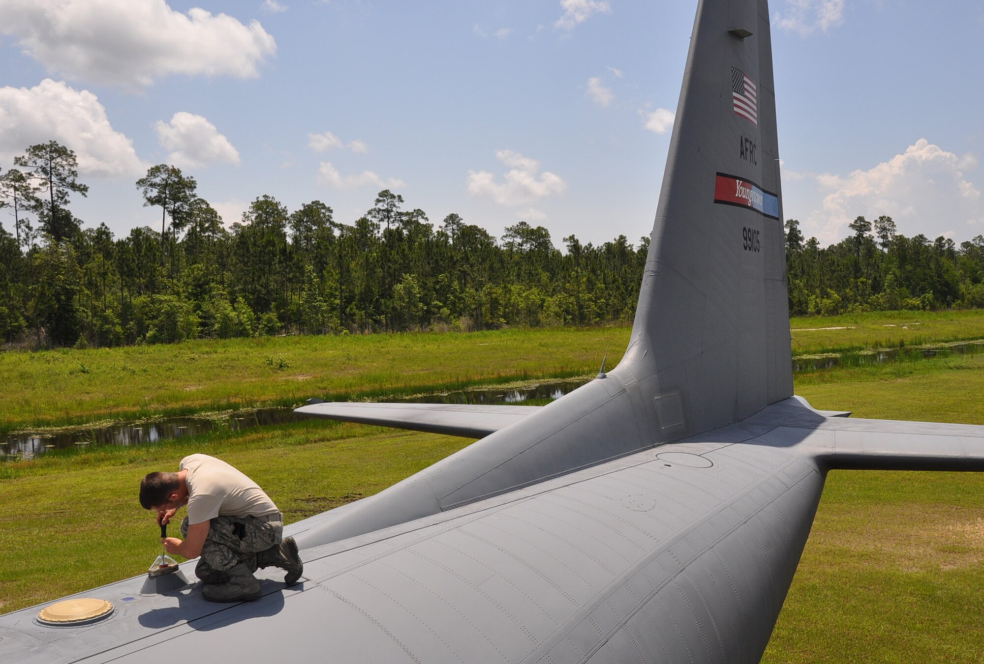 KILN, Miss. -- U.S. Air Force Reserve Staff Sgt. Samuel Miner, a crew chief with the 910th Aircraft Maintenance Squadron, inspects the C-130's top strobe light for moisture build up caused by high humidity in Southern Mississippi.  The strobe light is lit continuously when the C-130 is in flight giving it more visibility. Sergeant Miner and more than 50 YARS Reservists have been deployed to the Gulf of Mexico in support of the Deepwater Horizon oil spill mitigation since May 1. U.S. Air Force photo/Maj. Brent Davis