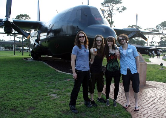 Halestorm band members (left to right) guitarist Joe Hottinger, drummer Arejay Hale, singer Lzzy Hale and bassist Josh Smith pose in front of an AC-130A Spectre at the Airpark at Hurlburt Field, Fla., May 25, 2010. The group's visit on base included the first live concert at the Landing Zone, as well as the band’s first appearance on a military installation. (DoD photo by Dianne Bitzes)