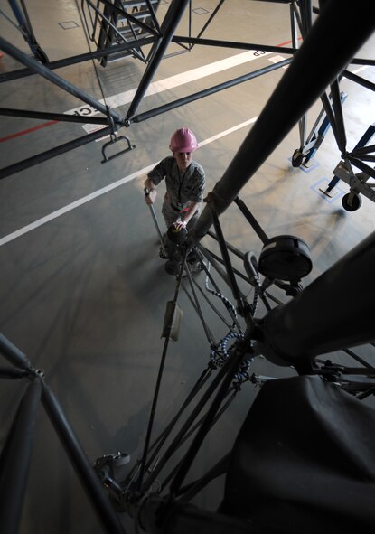 U.S. Air Force Senior Airman Stephanie Hall, 86th Maintenance Squadron isochronal crew chief, raises a jack up for support during an isochronal inspection, Ramstein Air Base, Germany, May 26, 2010. This is the first C-130J all active duty isochronal inspection done in the Air Force. (U.S. Air Force Photo by Airman 1st Class Caleb Pierce)