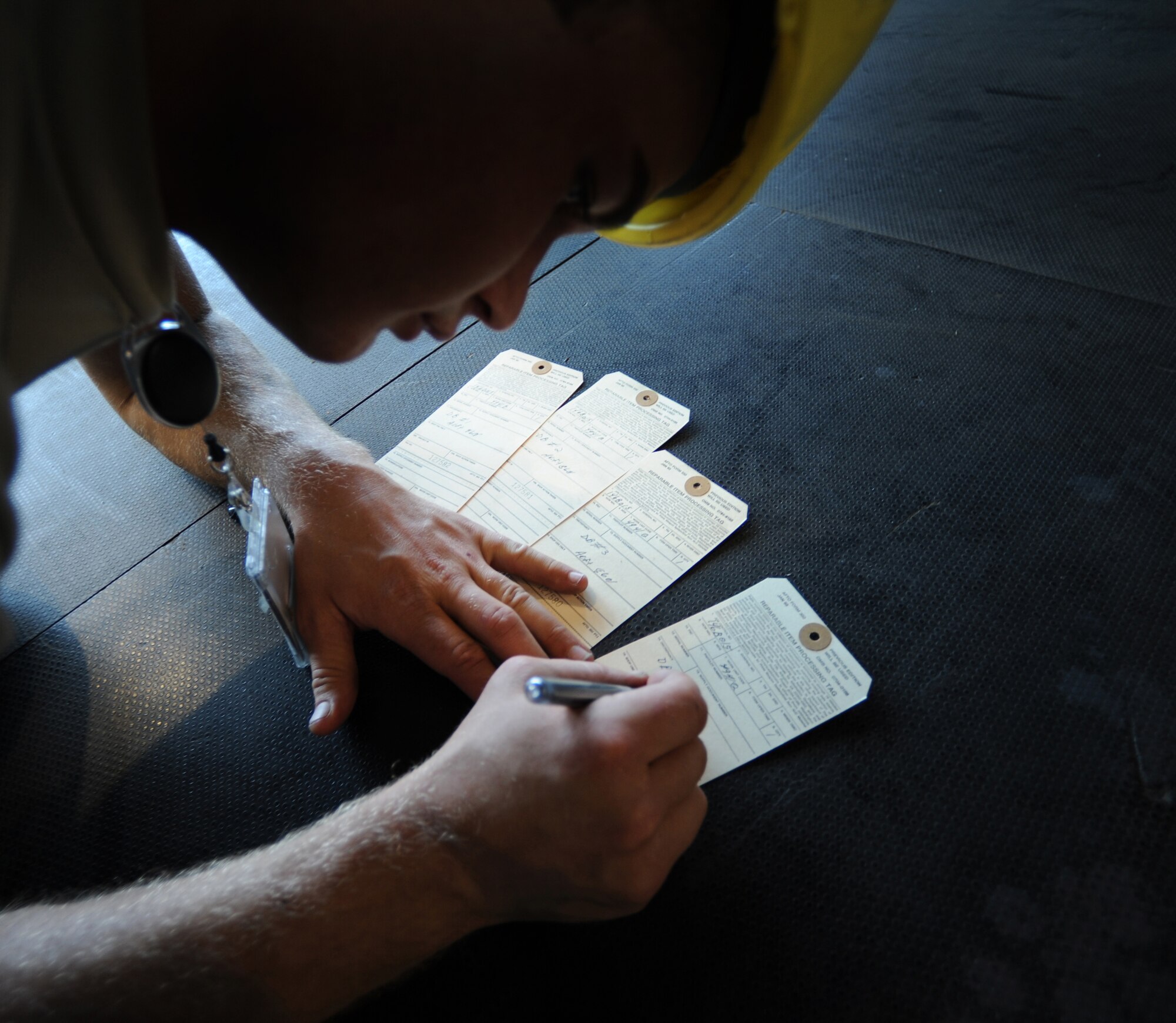 U.S. Air Force Airman 1st Class Randal Holt, 86th Maintenance Squadron isochronal crew chief, fills out inspection cards for parts on a C-130J during an isochronal inspection, Ramstein Air Base, Germany, May 26, 2010. This is the first C-130J all active duty isochronal inspection done in the Air Force. (U.S. Air Force Photo by Airman 1st Class Caleb Pierce)