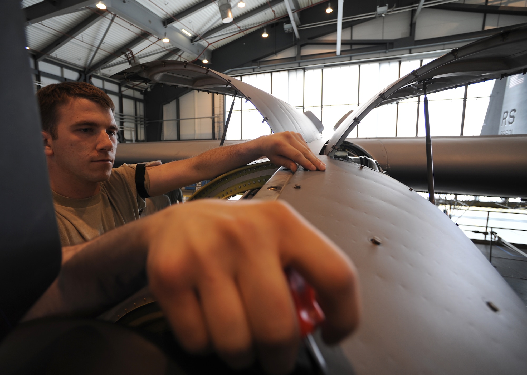 U.S. Air Force Staff Sgt. Joshua Coe, 86th Maintenance Squadron isochronal engine maintainer, depanels a turboprop on a C-130J during an isochronal inspection, Ramstein Air Base, Germany, May 26, 2010. This is the first C-130J all active duty isochronal inspection done in the Air Force. (U.S. Air Force Photo by Airman 1st Class Caleb Pierce)