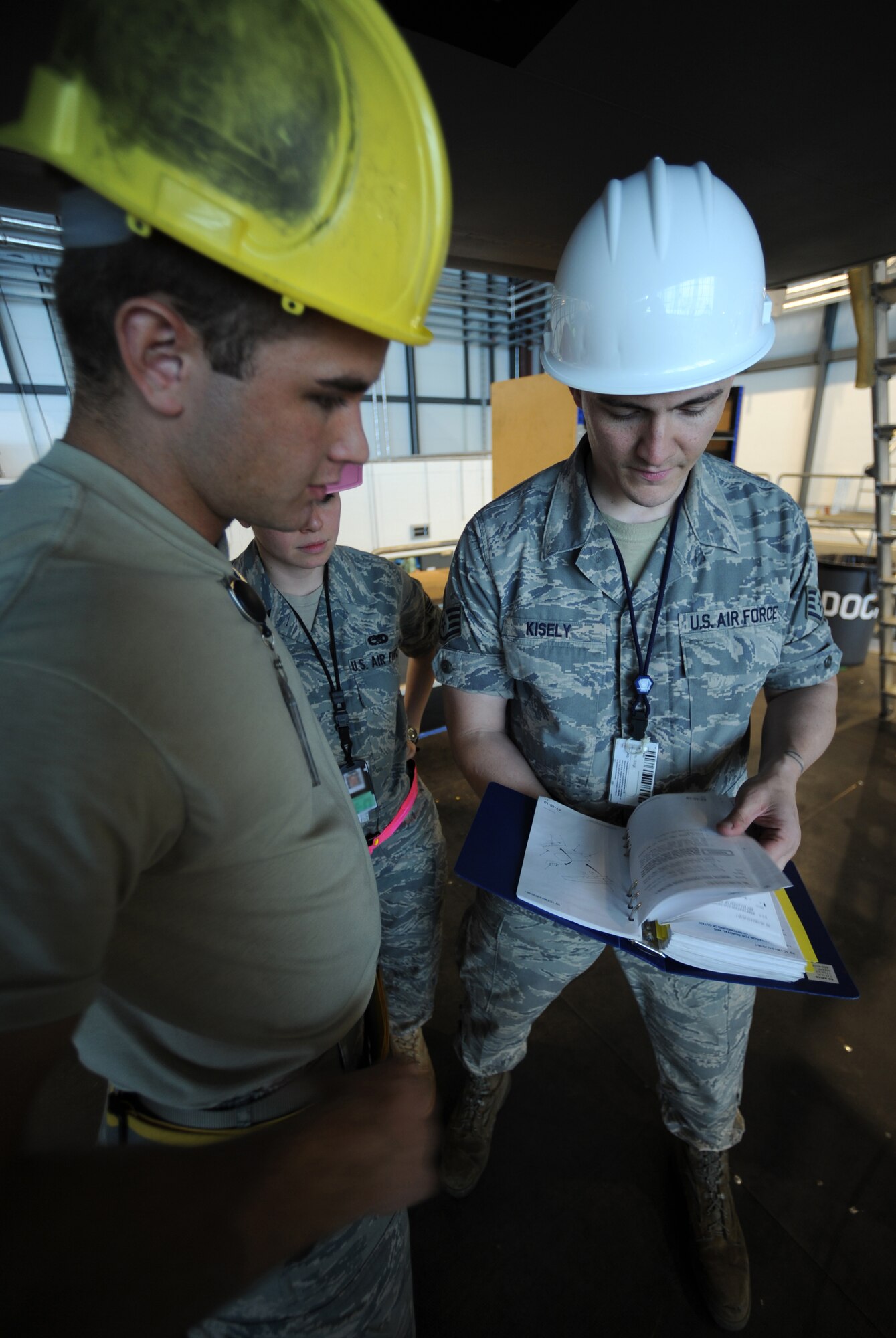 U.S. Air Force Airman Juan Romero and Staff Sgt. Brian Kisely, 86th Maintenance Squadron isochronal crew chiefs, check over a C-130J manual during an isochronal inspection, Ramstein Air Base, Germany, May 26, 2010. This is the first C-130J all active duty isochronal inspection done in the Air Force. (U.S. Air Force Photo by Airman 1st Class Caleb Pierce)