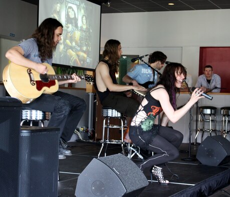 Halestorm band members (left to right) guitarist Joe Hottinger, drummer Arejay Hale, bassist Josh Smith and singer Lzzy Hale perform a song from their album during a special acoustic performance at the Landing Zone at Hurlburt Field, Fla., May 25, 2010. The concert was the first ever held at the venue, as well as the band’s first appearance on a military installation. (DoD photo by Dianne Bitzes)