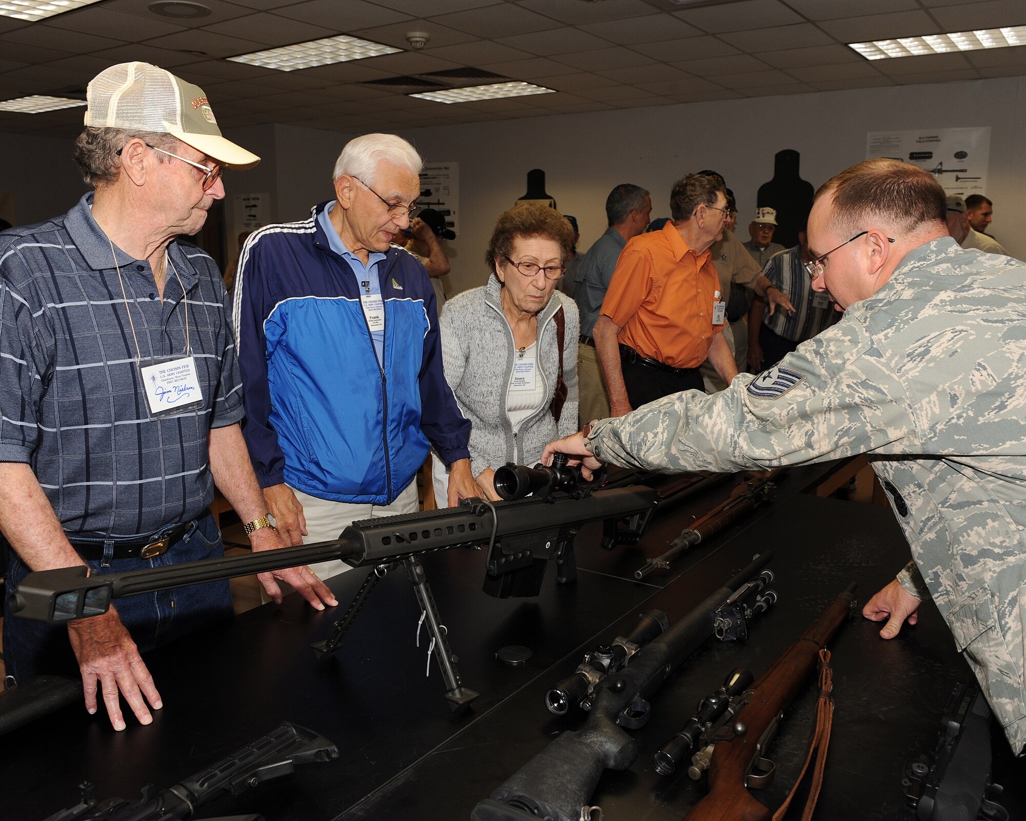James Nielsen, Korean War veteran and former prisoner of war; Frank Abasciano, Korean War veteran; and Grace Konisky listen as Tech. Sgt. James Allen, 19th Security Forces Squadron combat arms instructor, describes the capabilities of the Barrett.50 caliber rifle system May 21 during a tour of the combat arms training and maintenance facility. Mr. Nielsen and Mr. Abasciano were part of a group of soldiers that survived the epic 17-day battle in the Chosin Reservoir during the Korean War when 120,000 Chinese Communist Force’s soldiers attacked the U.S. Army’s Tenth Corps and another two Chinese Communist Forces divisions attacked the 1st Marine Division during one of the peninsula's coldest recorded winters.  (U.S. Air Force photo by Staff Sgt. Chad Chisholm)