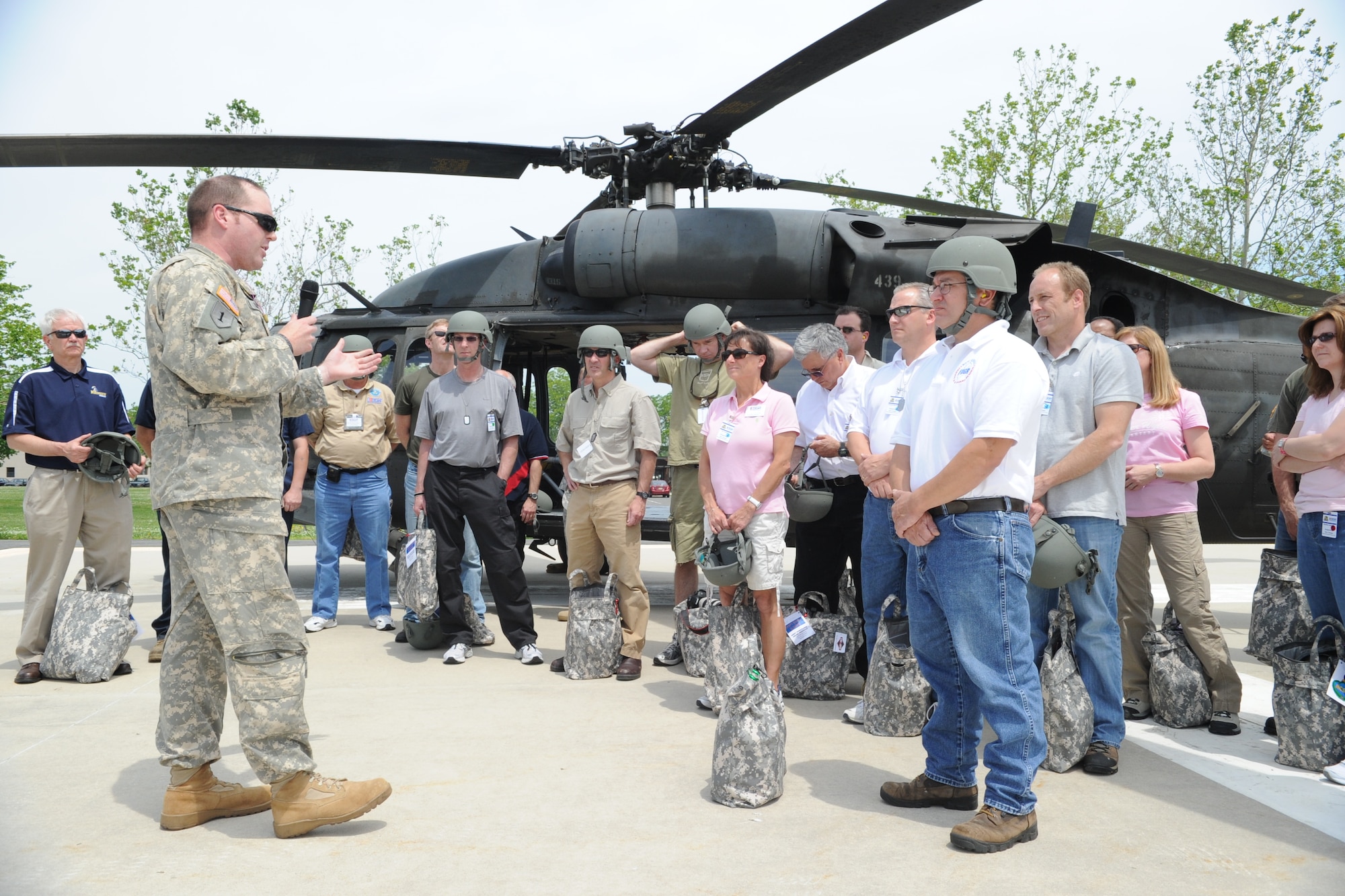 Civilian Boss Lift partners of Army Support Activity-Dix receive their flight safety briefing from black hawk crew chief Army Capt. Justin Oliver prior to the groups
departure from the garrison helipad at ASA-Dix headquarters to the Contingency
Operating Location in the Dix range complex. (U.S. Army photo/Pfc. Lukas McWhorter)