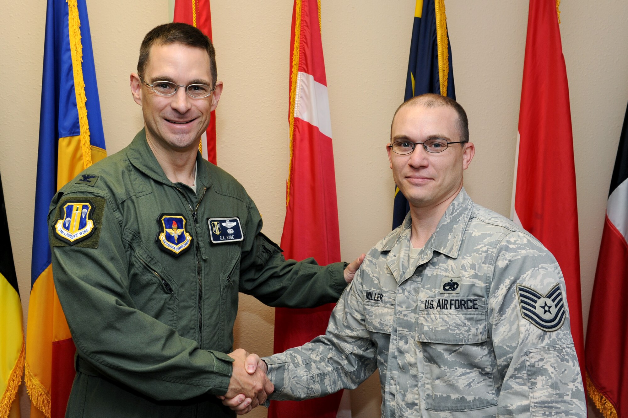 Col. C. K. Hyde, 314th Airlift Wing commander, presents a coin May 26 to Tech. Sgt. Richard Miller, 714th Training Squadron NCO-in-charge of the international military student office, for his selection as the Combat Airlifter of the Week. Sergeant Miller was critical in planning and executing two separate Department of State Field Studies Program trips, immersing 24 international students in U.S. culture and history with trips to Memphis, Tenn., or Washington, D.C. (U.S. Air Force photo by Senior Airman Ethan Morgan)