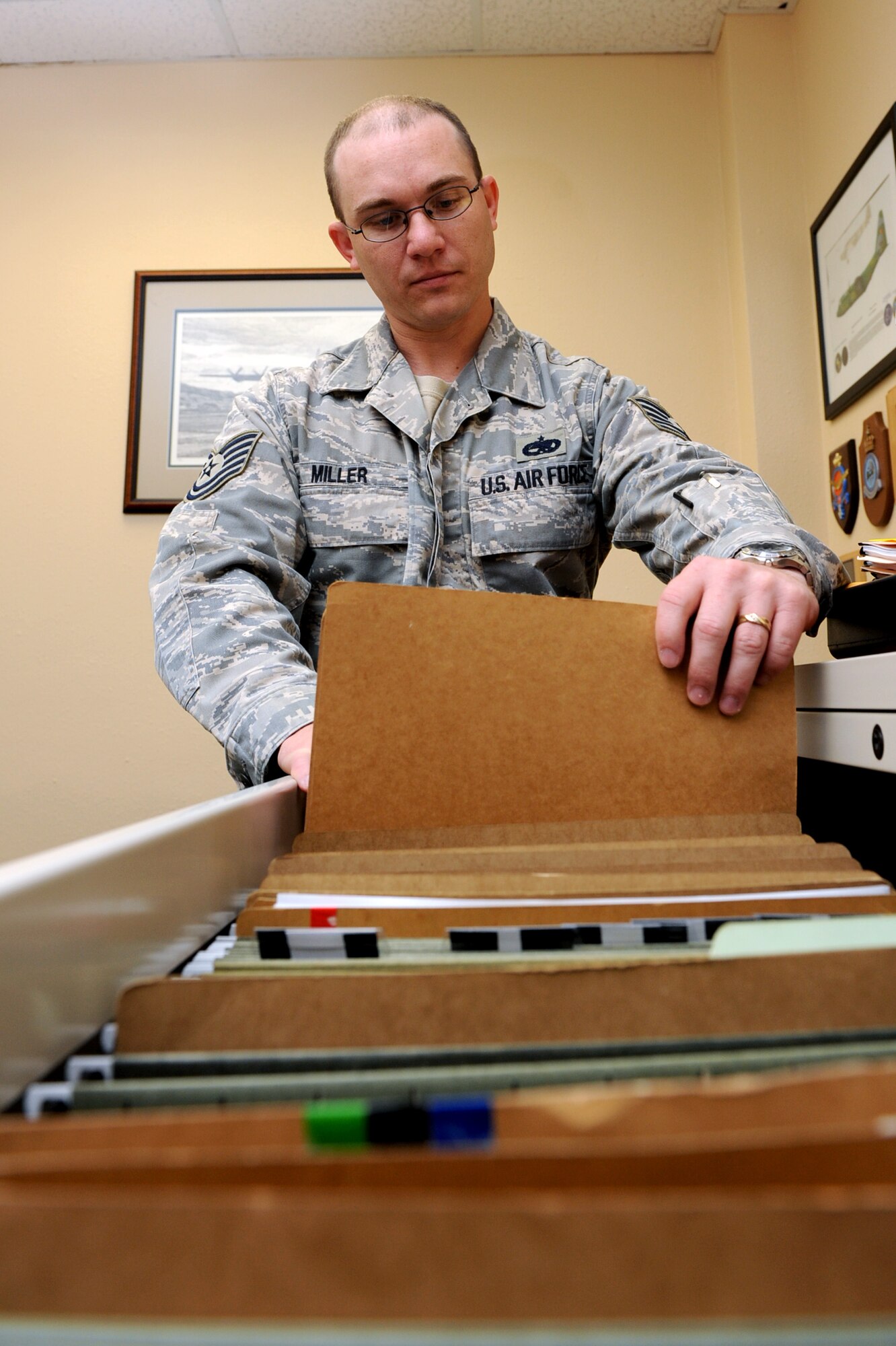 Tech. Sgt. Richard Miller, 714th Training Squadron NCO-in-charge of the international military student office, files student information May 26 used to report the status of Airmen training at Little Rock Air Force Base. Sergeant Miller directs administration, orders processing and leave and pass programs for more than 450 students daily, while providing direct support to international students in the Air Force’s largest international operations and maintenance training flight. (U.S. Air Force photo by Senior Airman Ethan Morgan)