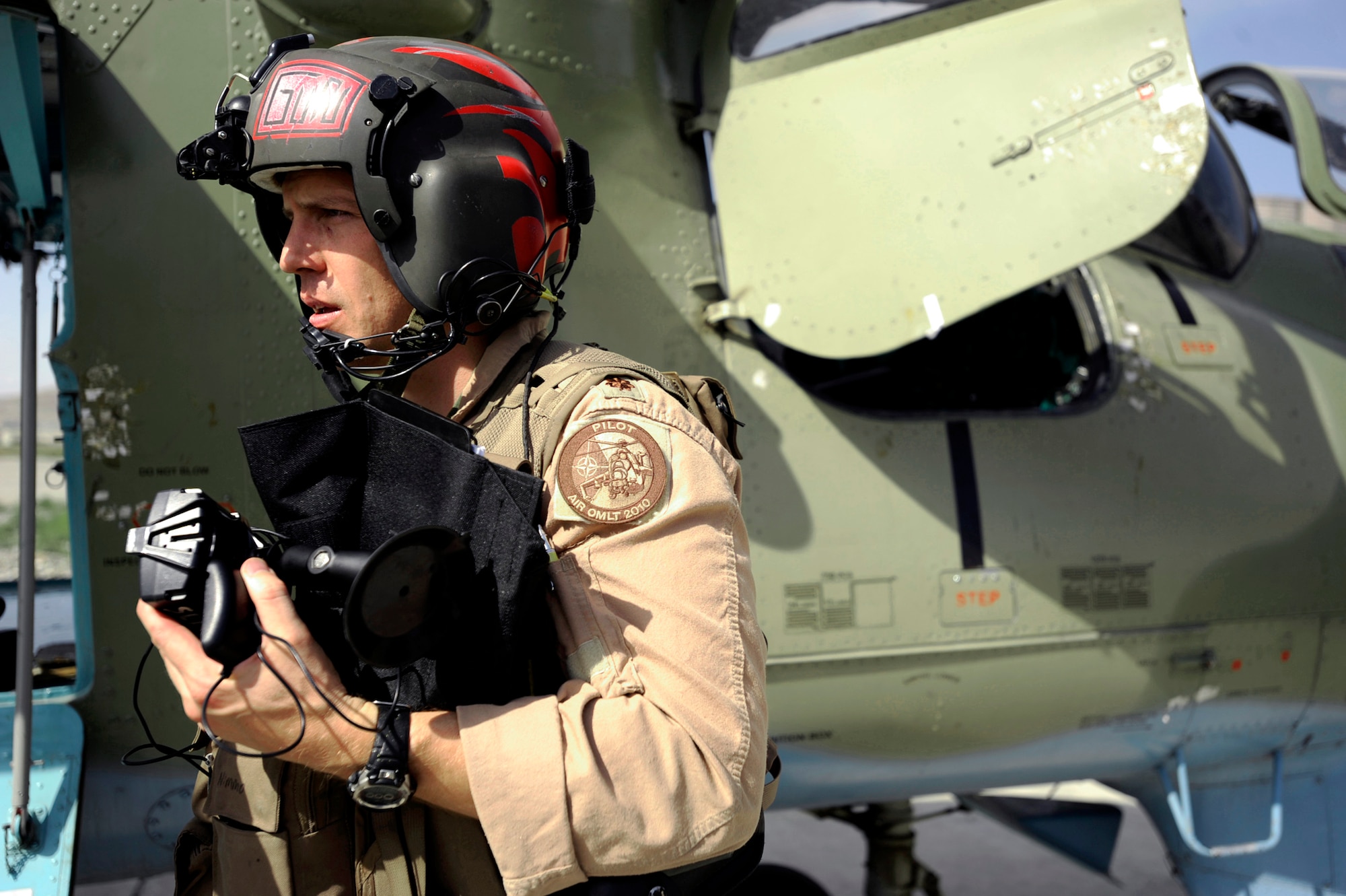 Maj. Caleb Nimmo exits an Mi-35 HIND E after returning from a live-fire training mission May 11, 2010, at Kabul International Airport, Afghanistan. Major Nimmo is a Mi-35 team lead assigned to the 440th Air Expeditionary Advisory Squadron. (U.S. Air Force photo/Staff Sgt. Manuel J. Martinez) 
