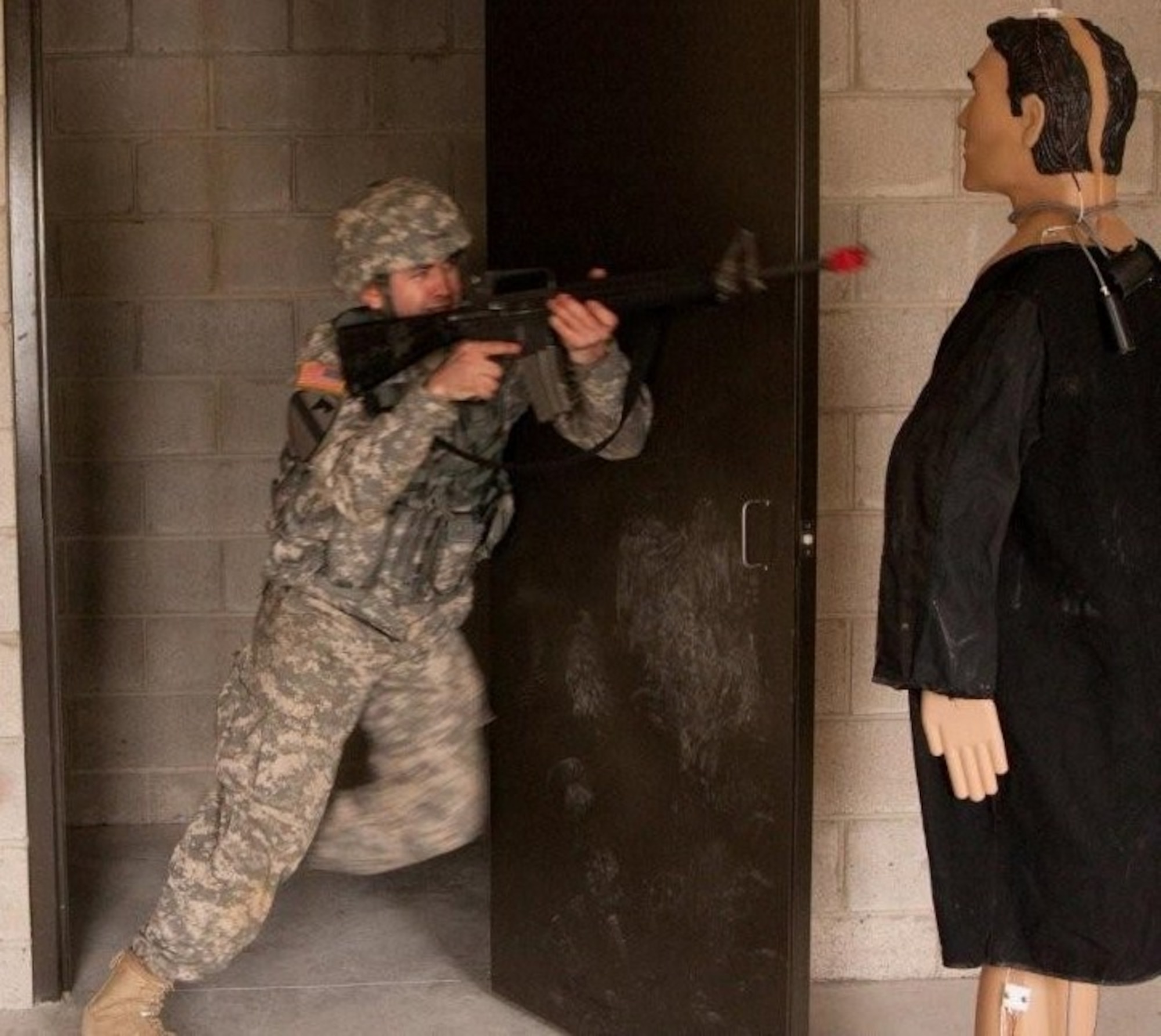 Sgt. Michael Brown, Delta Co. 3-385th, performs dynamic entry into a room during a four-day field training exercise here April 15..  The adversary is a human-dimensional target designed to fall when shot.  