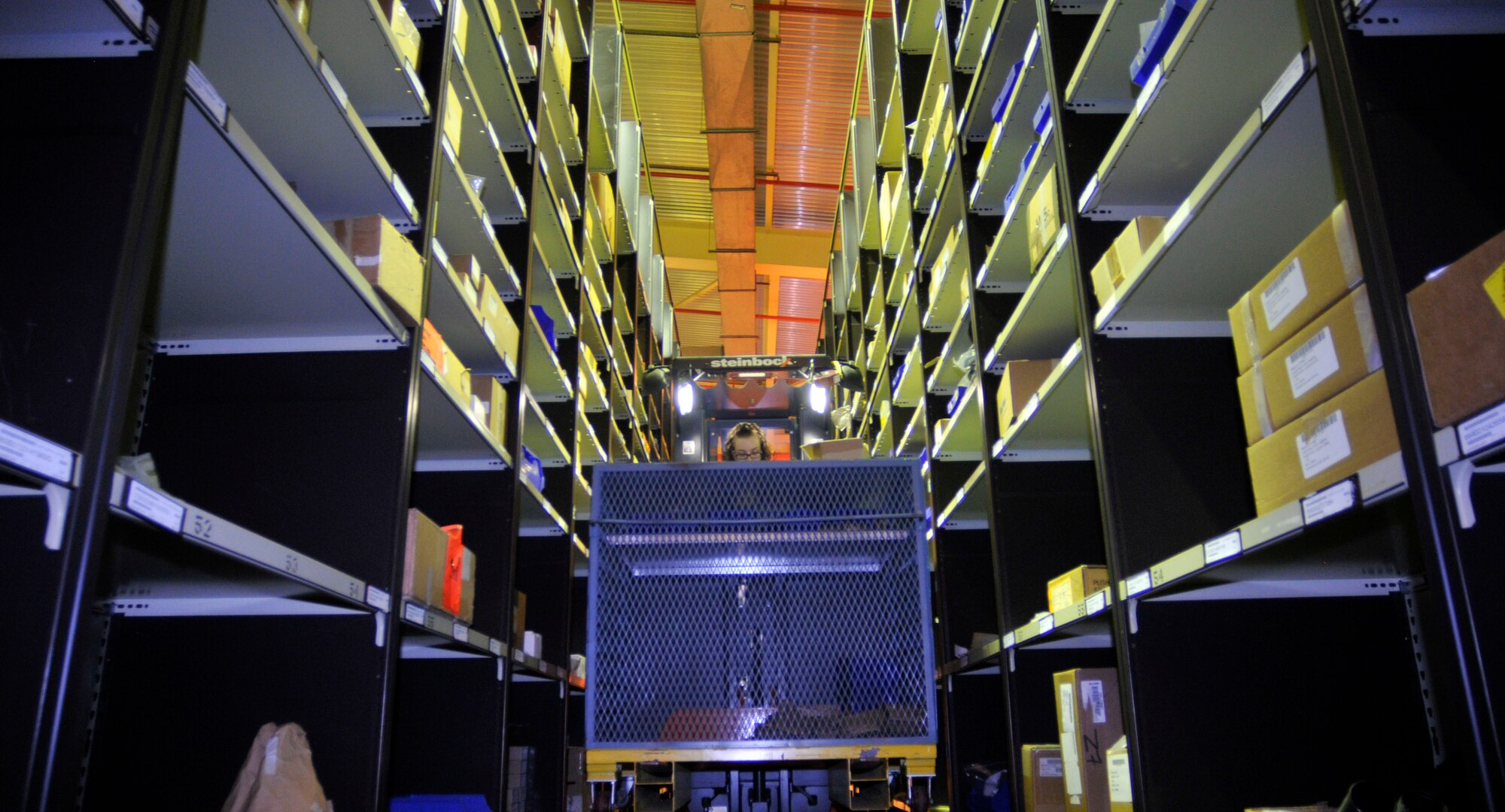 Airman Teresa Ritter, 48th Logistics Readiness Squadron central storage apprentice, operates a cherry picker while storing parts at the central storage warehouse at RAF Lakenheath May 18. The Airmen maintain positive control of more than 37 thousand parts, the parts range from aircraft components to washing detergent. (U.S. Air Force photo/Eboni Knox)