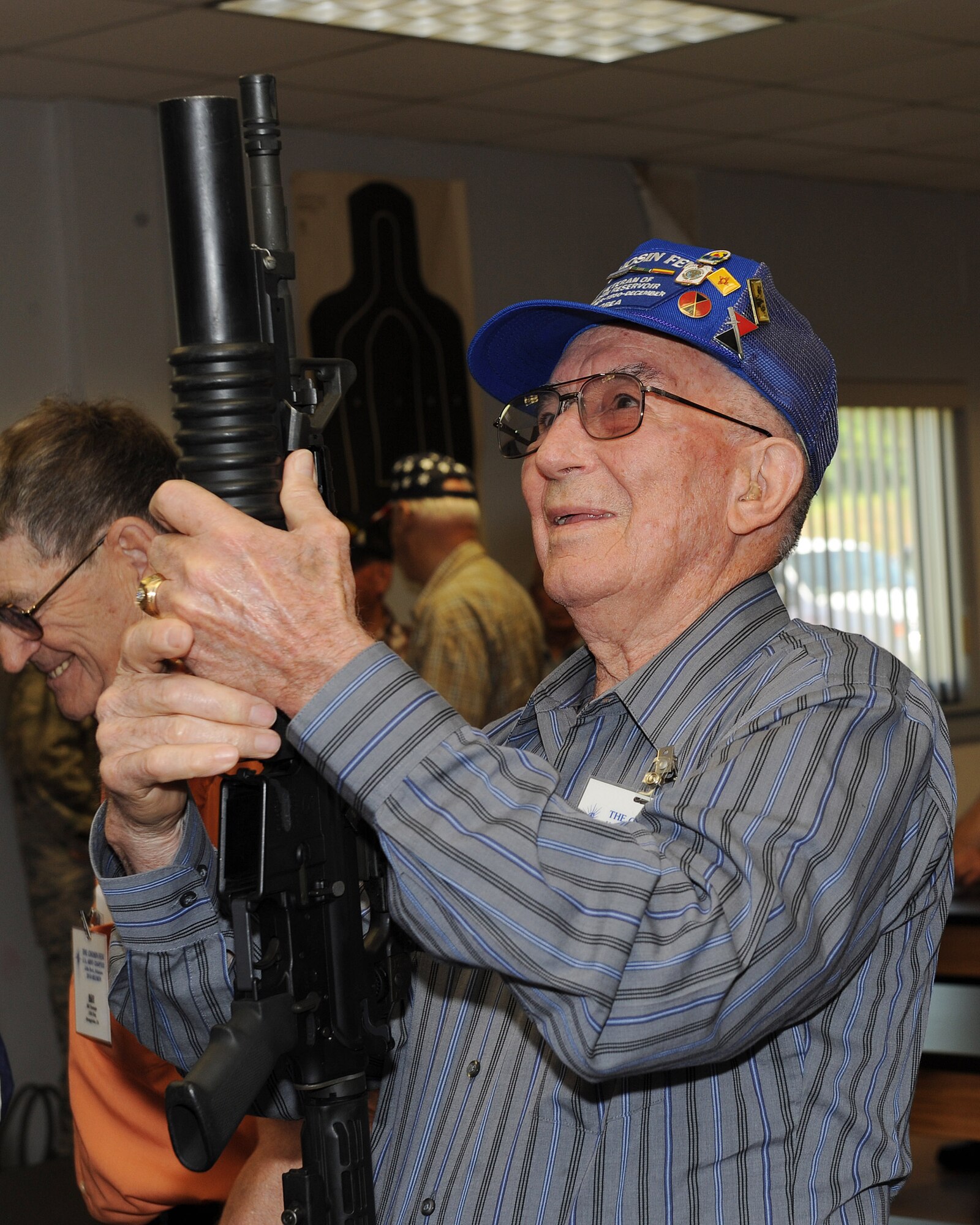 Retired Army Sgt. 1st Class Hollis Pantalion inspects an M-4 carbine with an attached M-203 grenade launcher May 21 during a tour of the combat arms training and maintenance facility. He’s one of the survivors of the epic battle of the Chosin Reservoir, serving in the 7th Infantry Division, 31st Regiment, Heavy Mortar Company during the Korean War. The Chosin Few visited Little Rock Air Force Base as part of their annual reunion tour for the first time in Little Rock since 1988. (U.S. Air Force photo by Staff Sgt. Chad Chisholm)