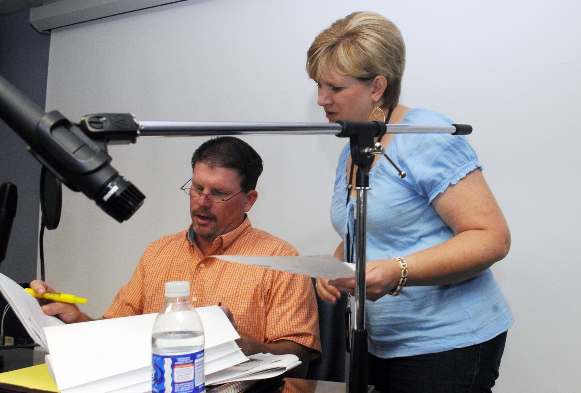 Show hosts Charles Wheeler and Twyla South go over their material before taping a show May 14. U. S. Air Force photo by Sue Sapp