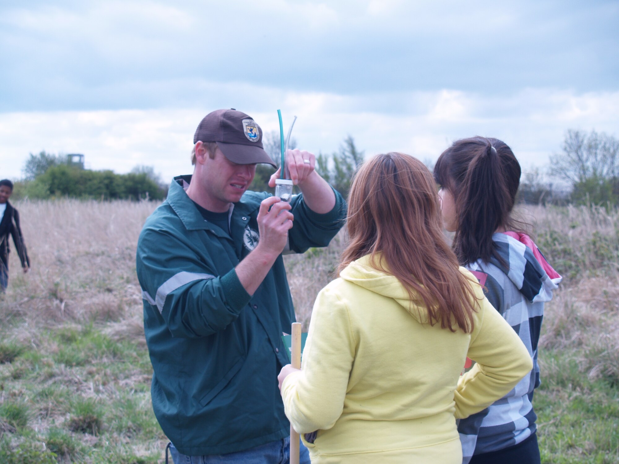 RAF MOLESWORTH, United Kingdom – Mr. Cogswell, the High School Science teacher at RAF Alconbury, aids in the identification of a collected insect with his students here May 10. The 423rd Natural Resources Management Flight and the Cambridgeshire Wildlife Trust supported a field day for the high school students on the RAF Molesworth county wildlife site.