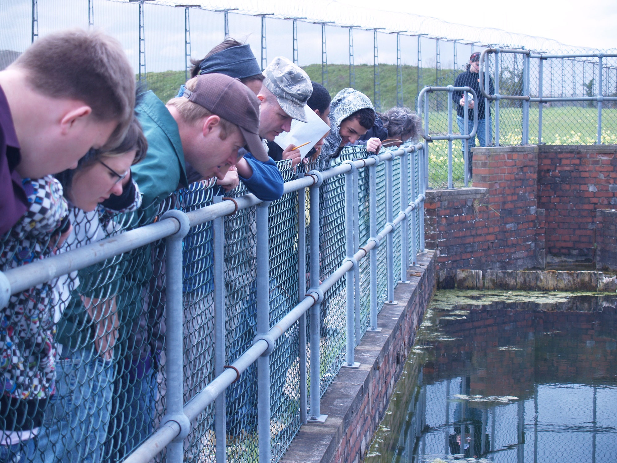 RAF MOLESWORTH, United Kingdom - Students from RAF Alconbury High School and environmentalists from the 423rd Civil Engineer Squadron in Natural Resource Management watch for Great Crested Newts, a listed endangered species, here May 10, 2010. The Cambridgeshire Wildlife Trust supported the field day at the county wildlife site. 