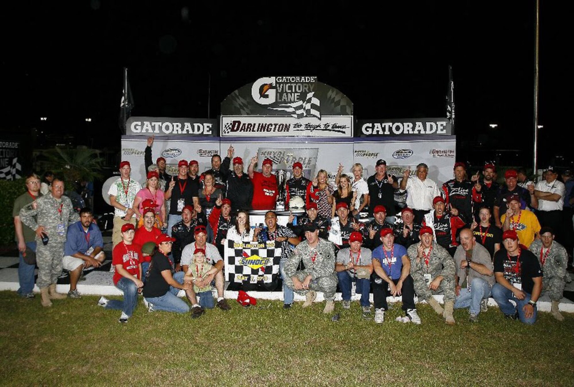 WinnersCircle: Soldiers, Marines, Airmen and their families join Denny Hamlin, Joe Gibbs Racing and Z-Line Designs in the victory celebration.  Photo courtesy of ?2010 Lesley Ann Miller, USA LAT Photographic