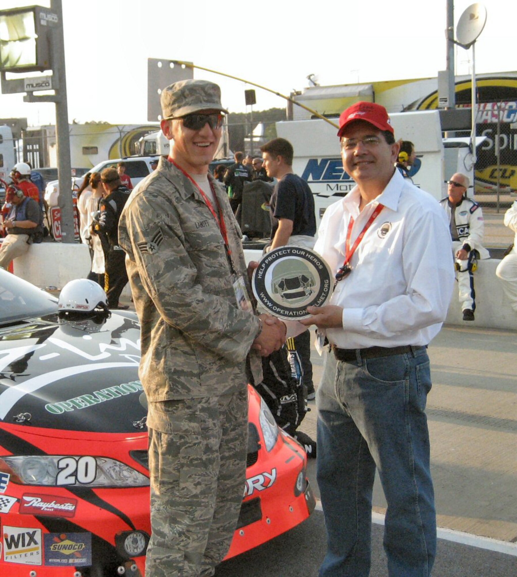 Mark Meaders of Operation Helmet presents a coin to Senior Airman Labott.  Photo by Mark Meaders, Operation Helmet