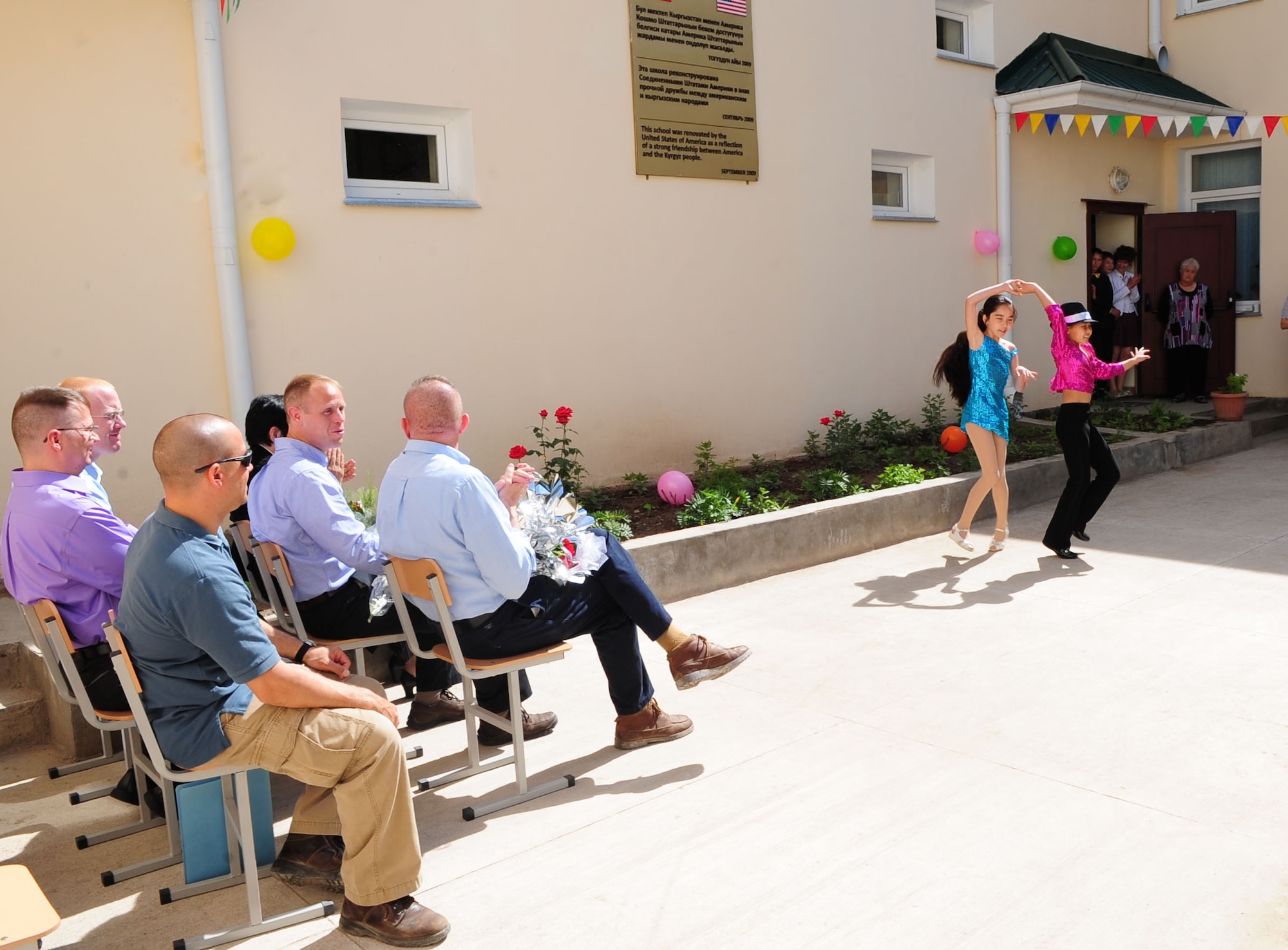 Children perform for audience members during a graduation ceremony for Birdik Village School, Kyrgyzstan, May 25, 2010. Airmen from the Transit Center at Manas were invited to participate in the event, which the children have been waiting for all year. Today's event was more important than ever before because the children were able to look back on the year's accomplishments and celebrate the reconstruction of the school that was complete just eight month ago, with the help of the Transit Center and the U.S. Embassy. (U.S. Air Force photo/ Senior Airman Nichelle Anderson/ released)