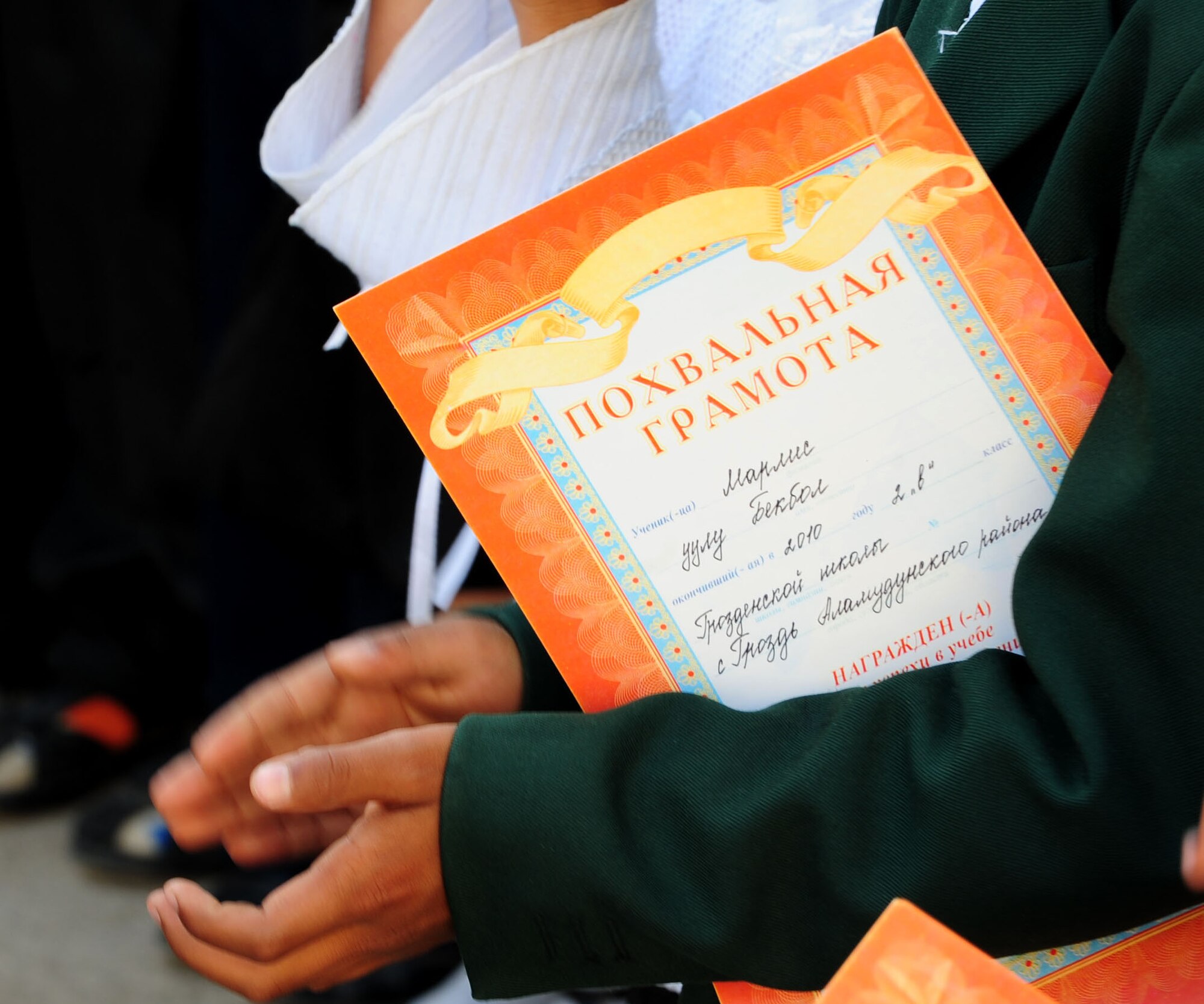 Children from the Birdik Village School, Kyrgyzstan, clap during a graduation ceremony at the school, marking the end of the school year May 25, 2010. Airmen from the Transit Center at Manas were invited to attend the celebration culminating the end of the school year. This year's ceremony was especially important because it was the first graduation since the reconstruction of the school last year. (U.S. Air Force photo/ Senior Airman Nichelle Anderson/ released)