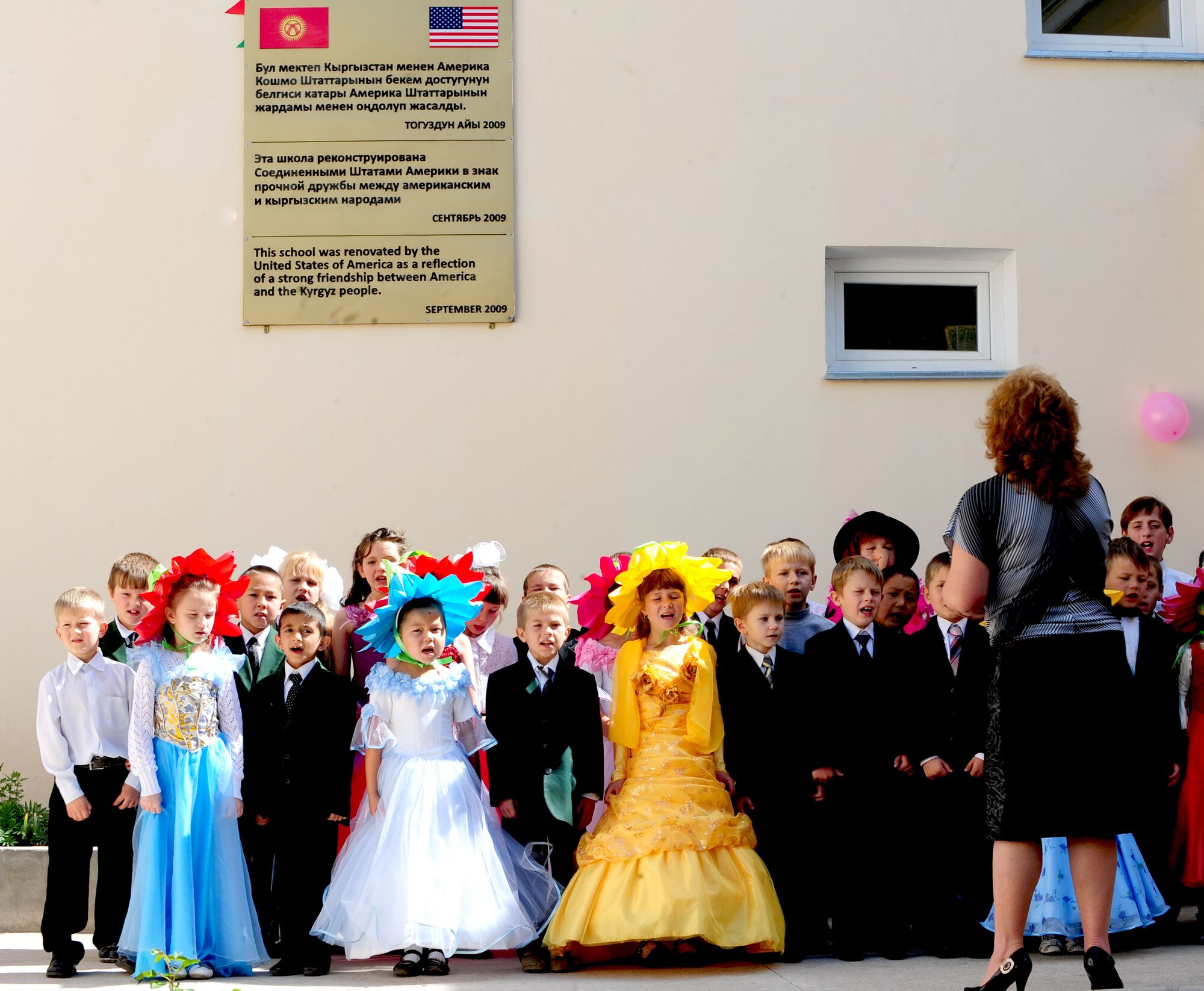 Children perform for audience members during a graduation ceremony for Birdik Village School, Kyrgyzstan, May 25, 2010. Airmen from the Transit Center at Manas were invited to participate in the event, which the children have been waiting for all year. Today's event was more important than ever before because the children were able to look back on the year's accomplishments and celebrate the reconstruction of the school that was complete just eight month ago, with the help of the Transit Center and the U.S. Embassy. (U.S. Air Force photo/ Senior Airman Nichelle Anderson/ released)