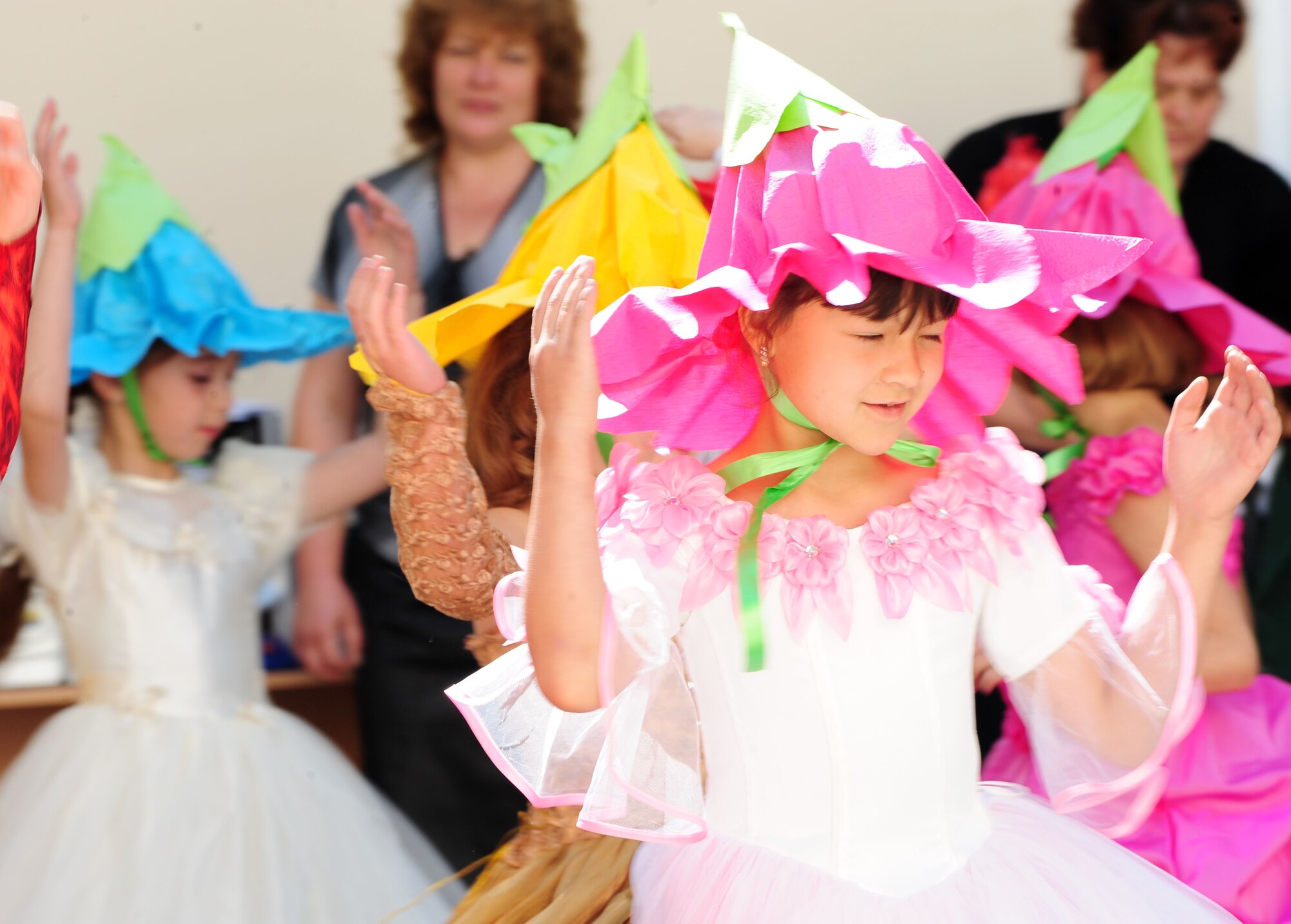 Children perform for audience members during a graduation ceremony for Birdik Village School, Kyrgyzstan, May 25, 2010. Airmen from the Transit Center at Manas were invited to participate in the event, which the children have been waiting for all year. Today?s event was more important than ever before because the children were able to look back on the year?s accomplishments and celebrate the reconstruction of the school that was complete just eight month ago, with the help of the Transit Center and the U.S. Embassy. (U.S. Air Force photo/ Senior Airman Nichelle Anderson/ released)