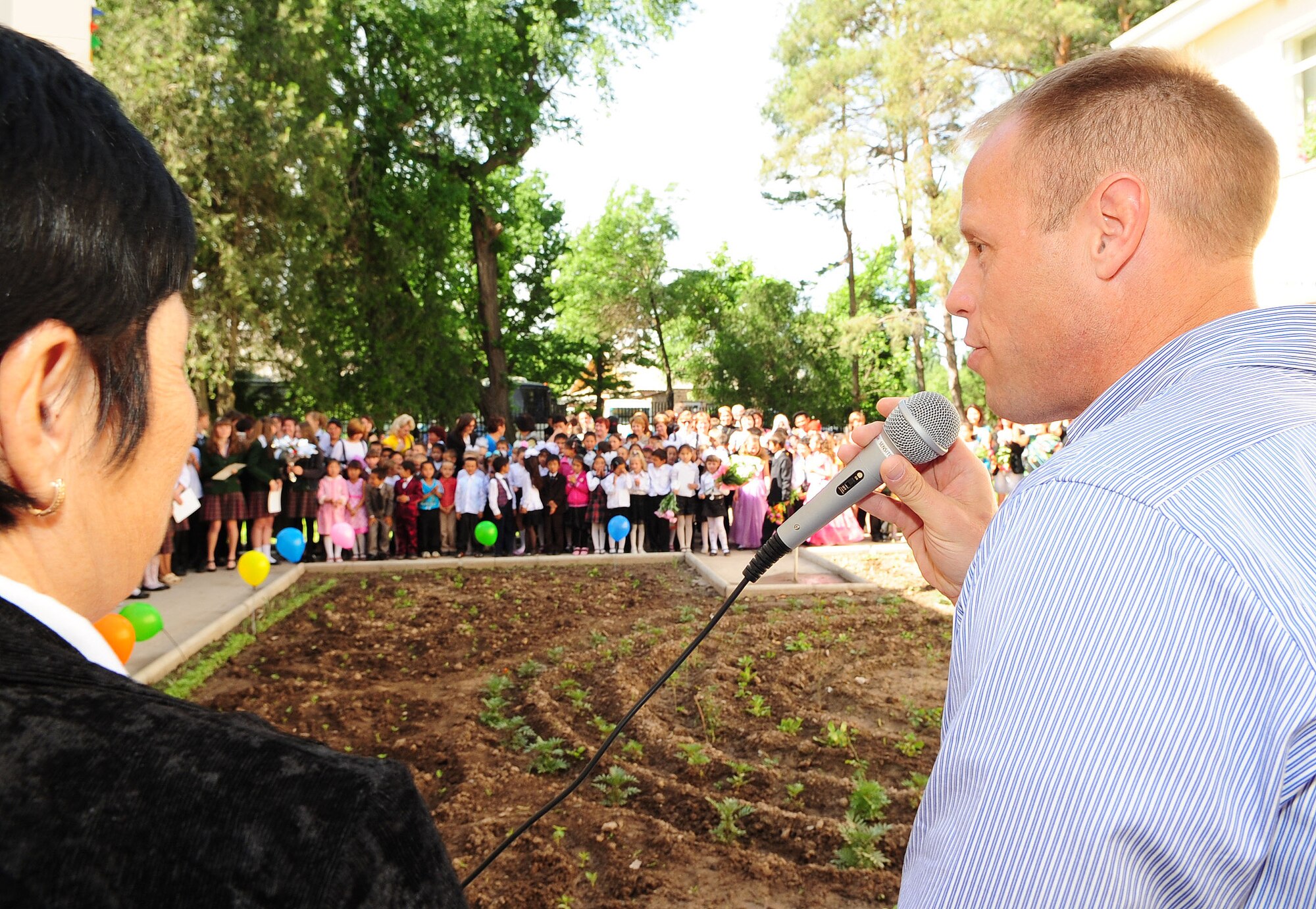 Col. Blaine Holt, Director of the Transit Center at Manas, Kyrgyzstan, gives a brief speech during a graduation ceremony for children at the Birdik Village School May 25, 2010. During his speech, Colonel Holt presented the school with a bus donated by the Transit Center. (U.S. Air Force photo/ Senior Airman Nichelle Anderson/ released)