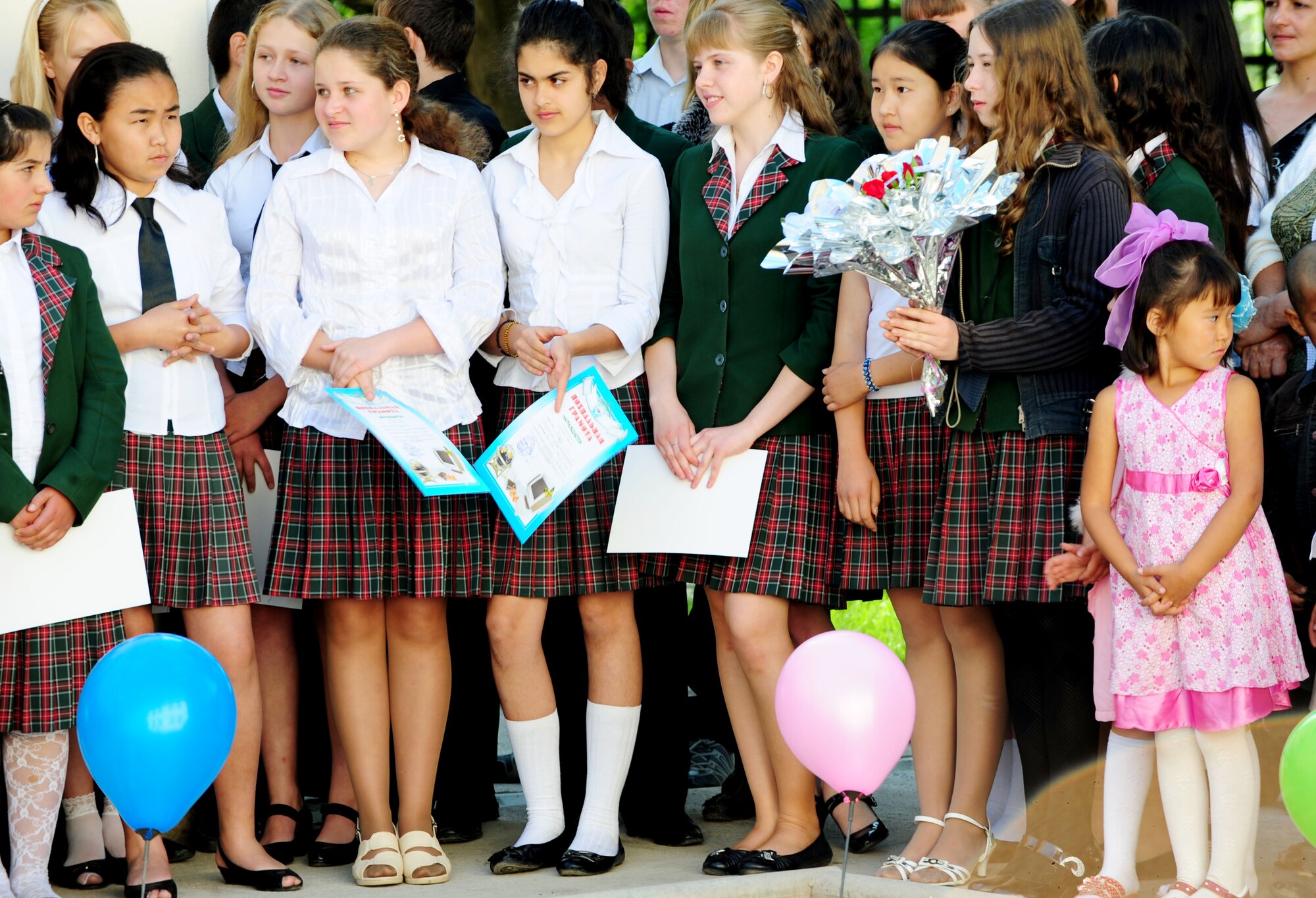 Children from the Birdik Village School, Kyrgyzstan, listen and wait in anticipation for the last bell during a graduation ceremony at the school May 25, 2010. Airmen from the Transit Center at Manas were invited to attend the celebration culminating the end of the school year. This year's ceremony was especially important because it was the end of the first school year since the reconstruction of the school. (U.S. Air Force photo/ Senior Airman Nichelle Anderson/ released)