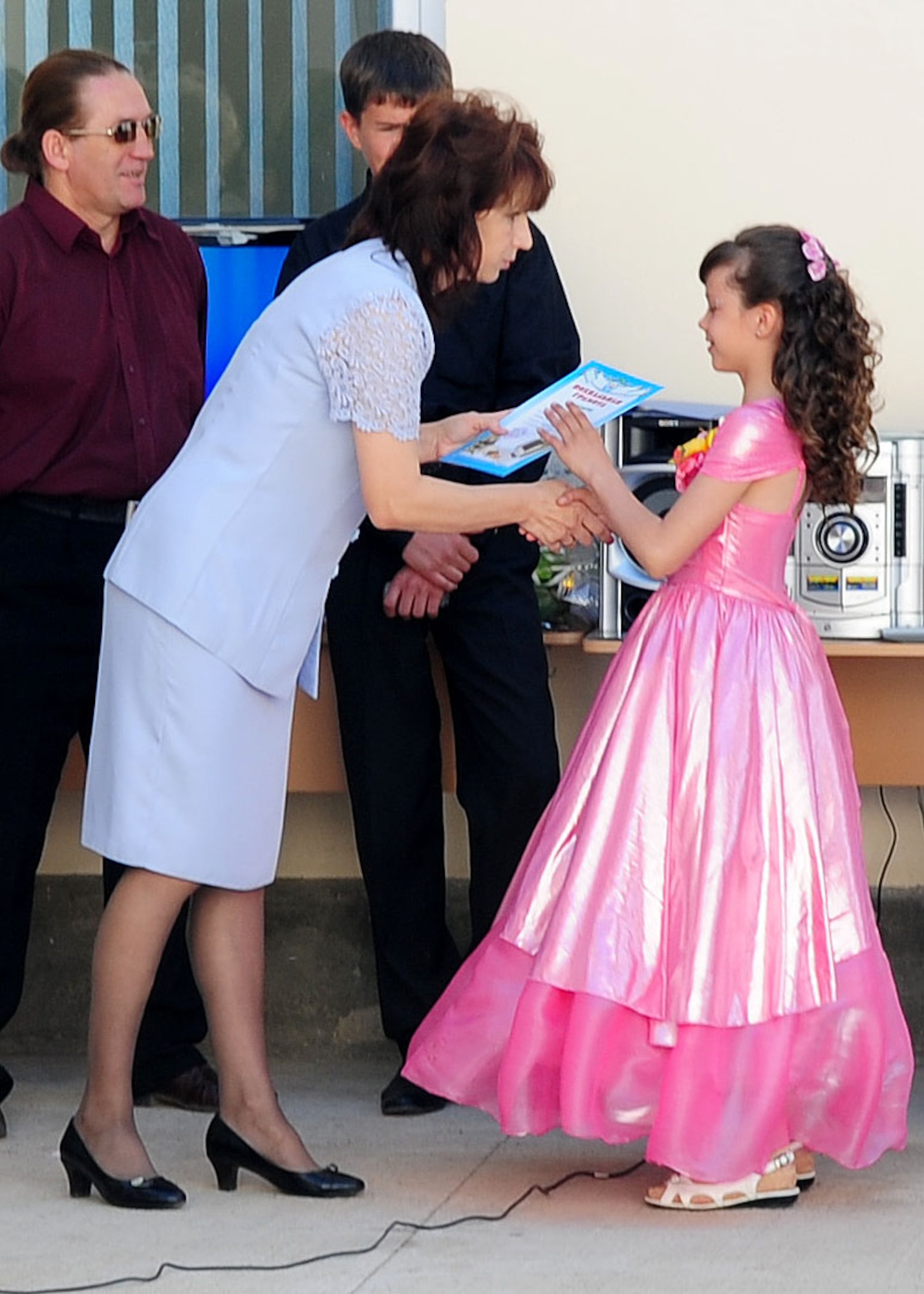 A child receives a certificate culminating the completion of the school year at the Birdik Village School, Kyrgyzstan, May 25, 2010. Airmen from the Transit Center at Manas were invited to the graduation ceremony to help the children celebrate the end of the first school year since the completion of a recent reconstruction project. The project, which cost about $540,000, was funded by the Air Force and made possible by volunteer efforts from Airmen at the Transit Center at Manas, Kyrgyzstan. The ribbon cutting was held Sept. 1, 2009. (U.S. Air Force photo/ Senior Airman Nichelle Anderson/ released)