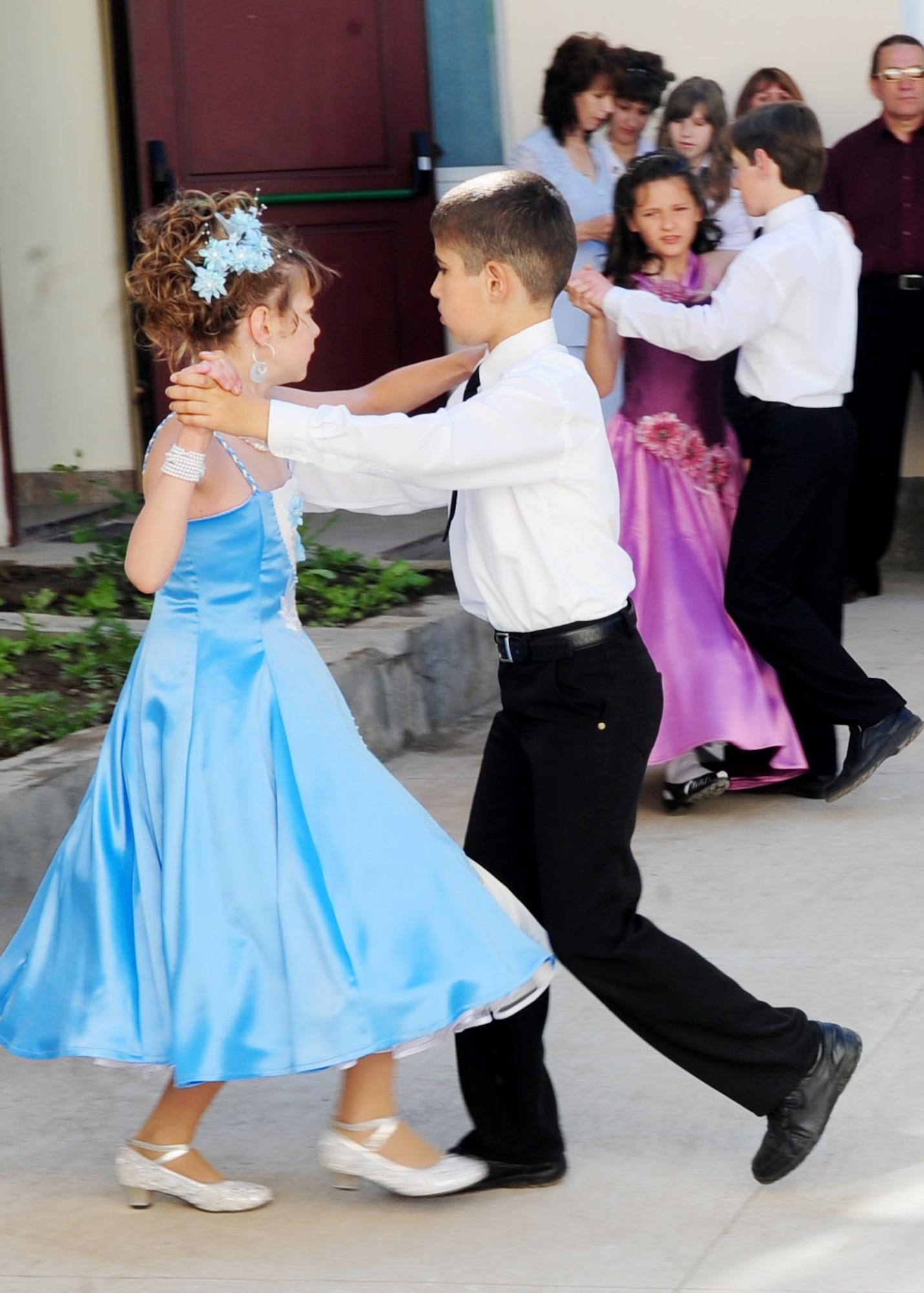 Children perform for audience members during a graduation ceremony for Birdik Village School, Kyrgyzstan, May 25, 2010. Airmen from the Transit Center at Manas were invited to participate in the event, which the children have been waiting for all year. Today's event was more important than ever before because the children were able to look back on the year's accomplishments and celebrate the reconstruction of the school that was complete just eight month ago, with the help of the Transit Center and the U.S. Embassy. (U.S. Air Force photo/ Senior Airman Nichelle Anderson/ released)