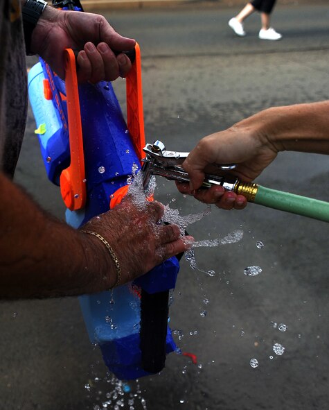 JOINT BASE PEARL HARBOR HICKAM, Hawaii -- Hickam Spectators took part in the Beach Bum Parade Parade began at Bishop's Point Pier and ended at Hickam Harbor with free food and entertainment at Foster Point Pavilion. Those who wanted to were able to campout at Hickam Harbor after the parade for a fun, family night, gathered around a campfire for free s'mores. Once the sun set, campers enjoyed a movie on the beach on a large outdoor movie screen. (U.S. Air Force photo/Staff Sgt. Mike Meares) 