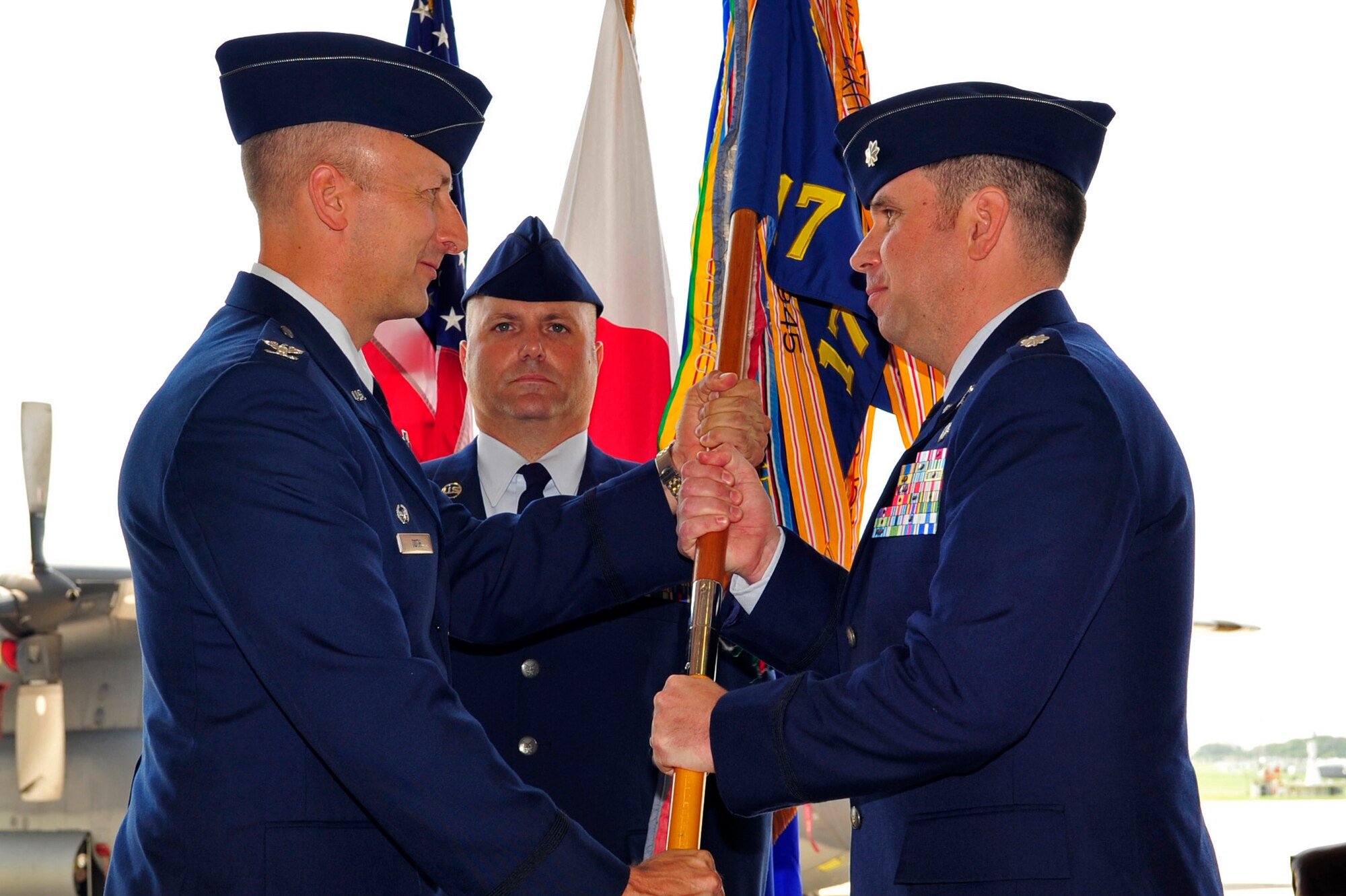 Lt. Col. Eric D. Zimmerman assumes command after accepting the 17th Special Operations Squadron flag from Col. Robert Toth, 353rd Special Operations Group commander, during a change of command ceremony May 26, 2010. (U.S. Air Force photo/Senior Airman Amanda Grabiec)