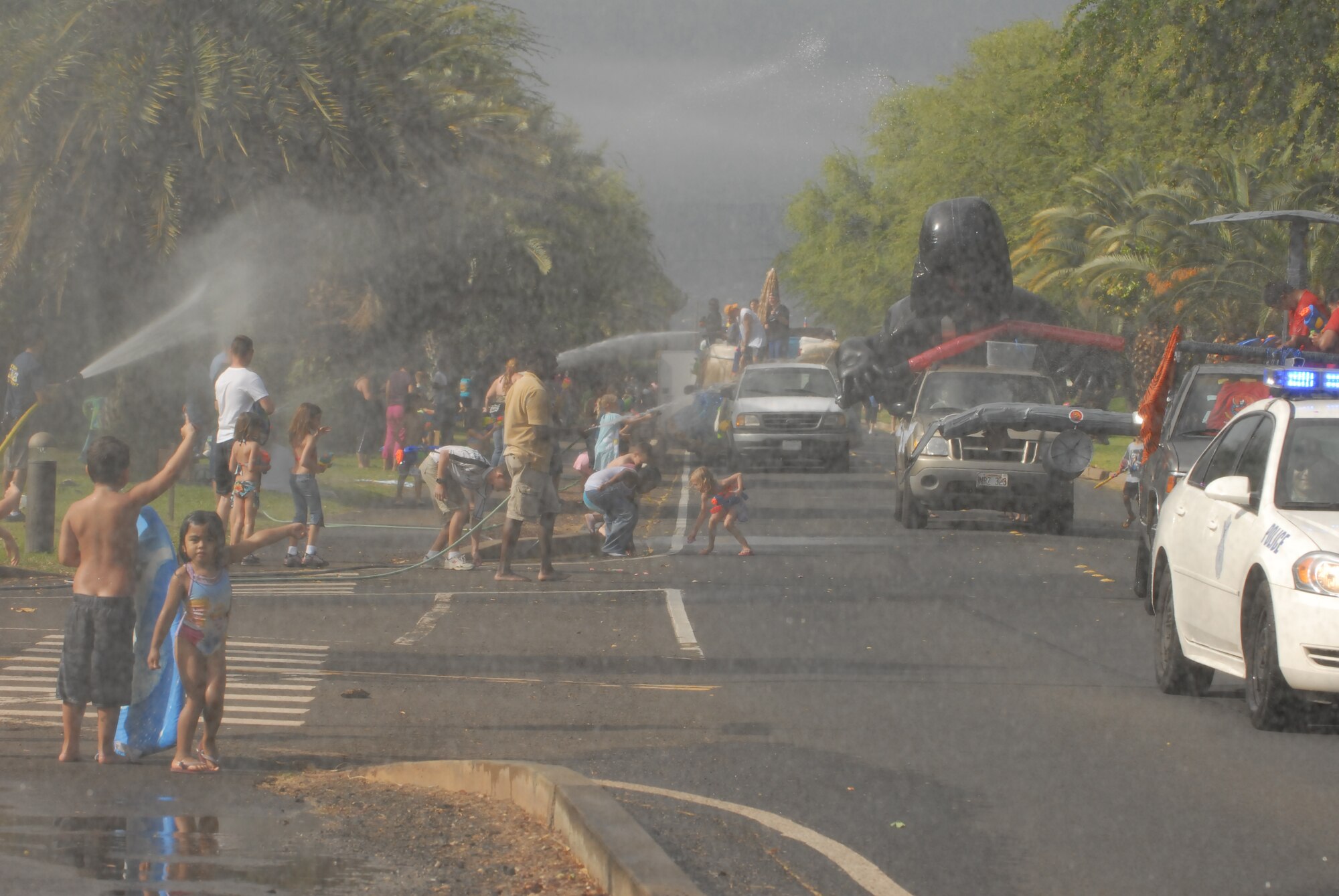 JOINT BASE PEARL HARBOR HICKAM, Hawaii -- Hickam Spectators took part in the Beach Bum Parade Parade began at Bishop's Point Pier and ended at Hickam Harbor with free food and entertainment at Foster Point Pavilion. Those who wanted to were able to campout at Hickam Harbor after the parade for a fun, family night, gathered around a campfire for free s'mores. Once the sun set, campers enjoyed a movie on the beach on a large outdoor movie screen. (U.S. Air Force photo/Staff Sgt. Mike Meares) 